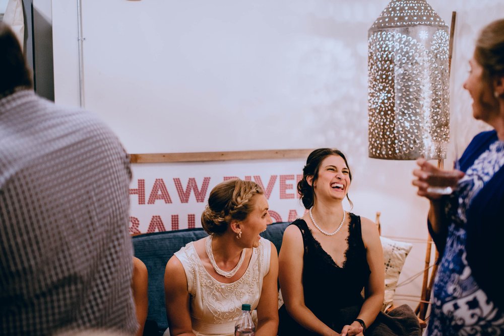 bride sharing a laugh with family and friends before the wedding ceremony