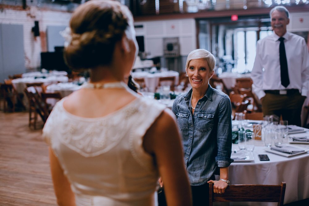 bride is ecstatic to see her bride all dressed up and ready for their haw river ballroom wedding