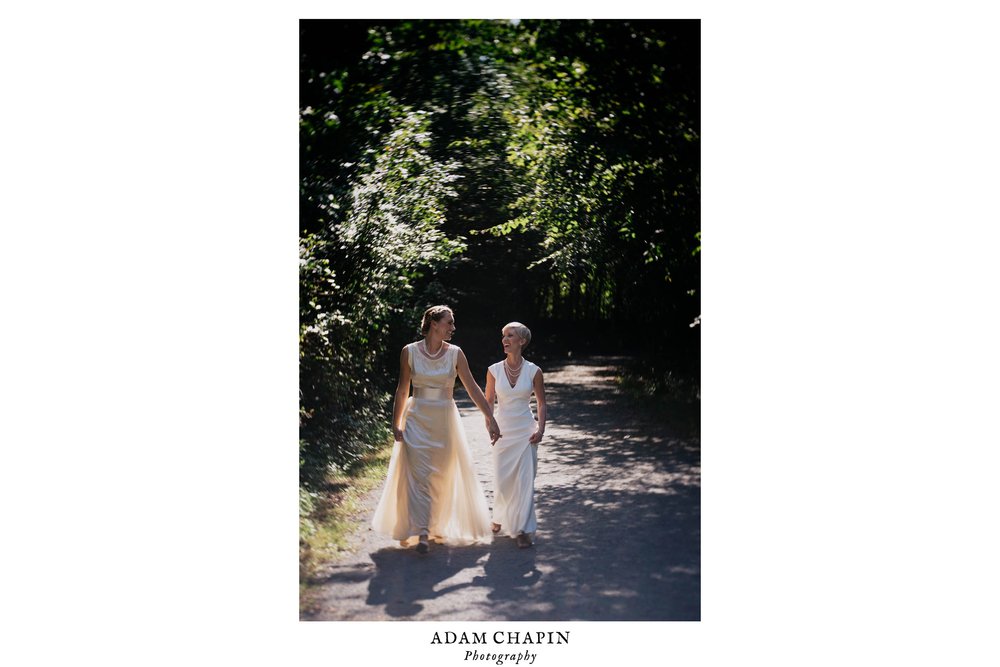 brides walking the trails around saxapahaw together before their wedding ceremony