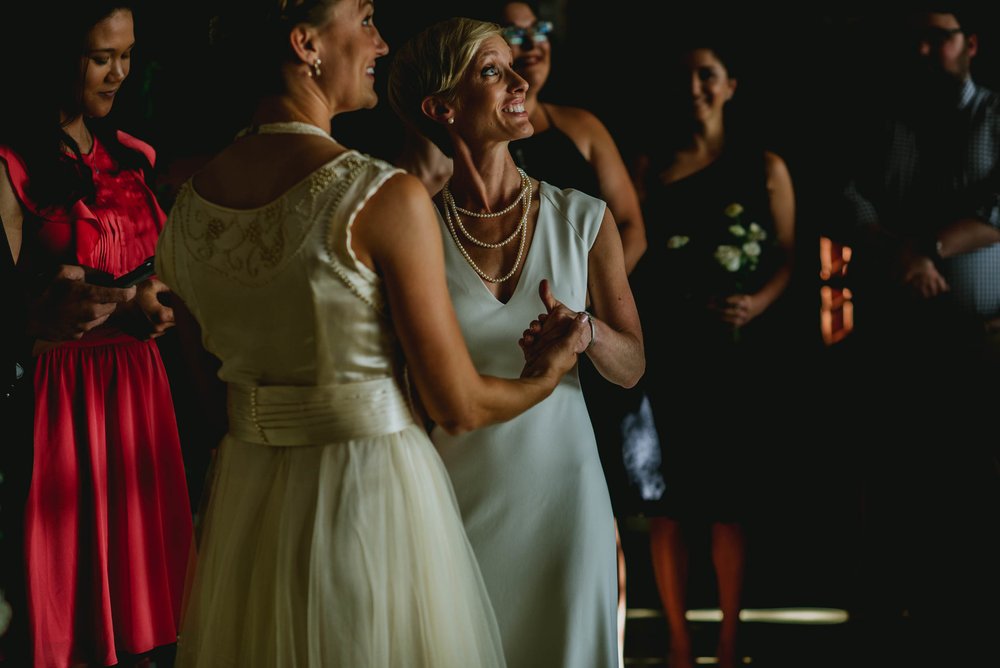 brides look up to balcony during ceremony