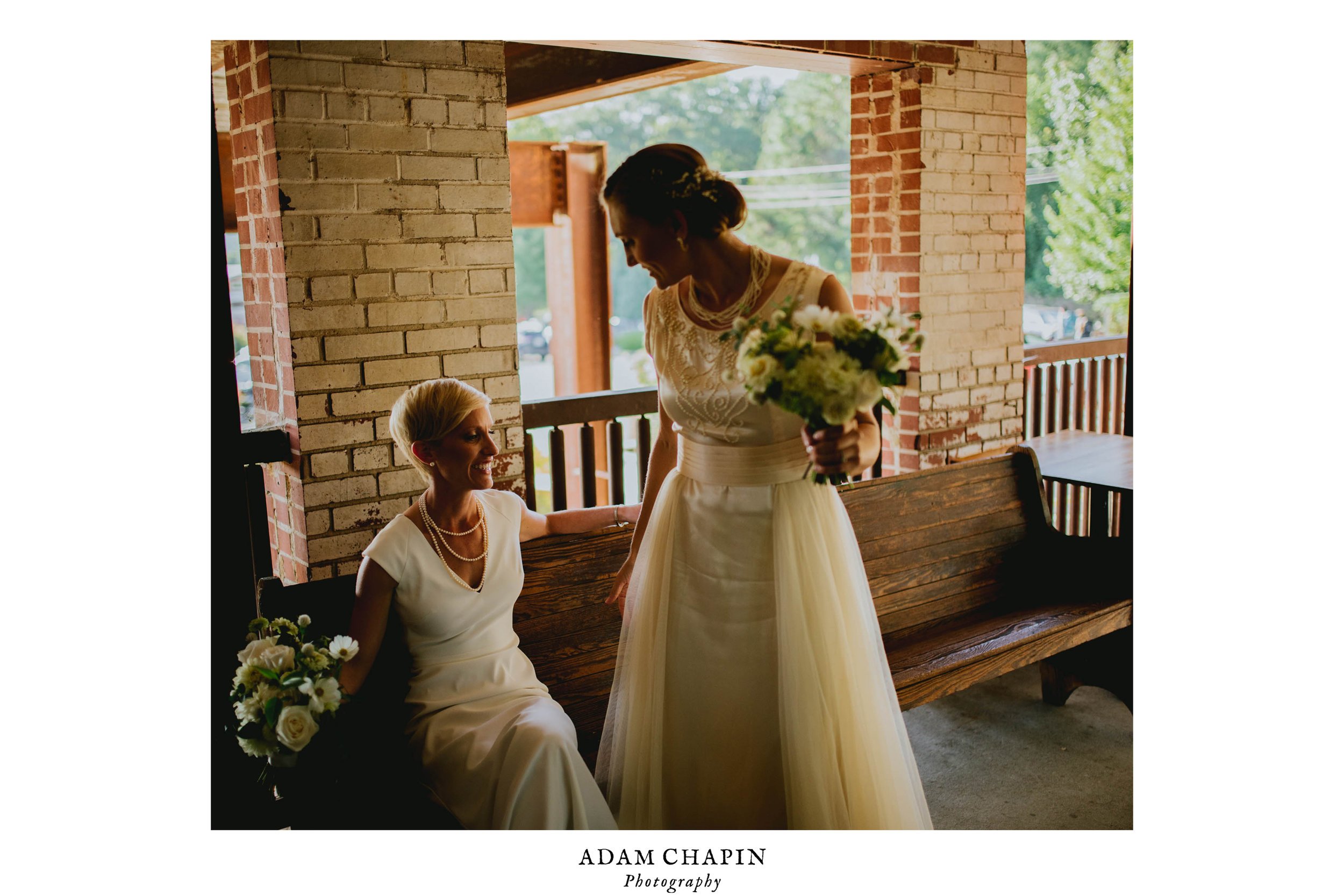 brides sharing a laugh just after their haw river ballroom wedding