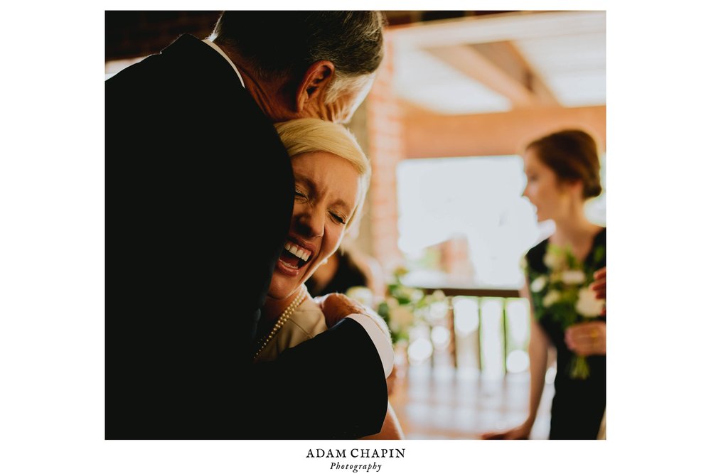 bride hugs her father in law after ceremony