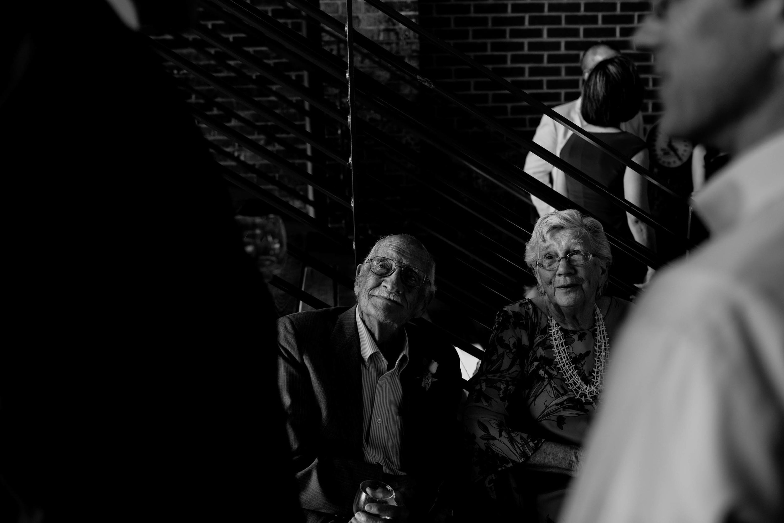 grandparents of the bride enjoying conversation with other wedding guests at the haw river ballroom