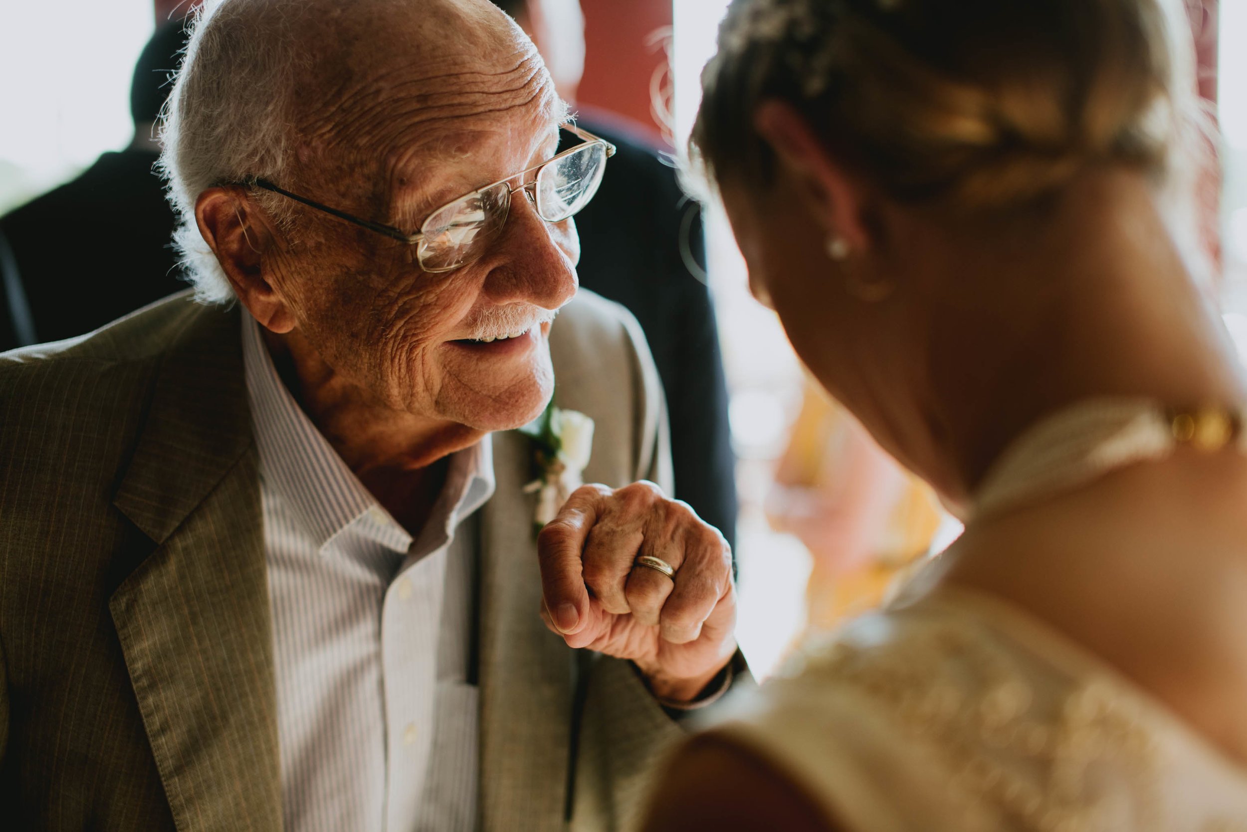 bride and her grandfather sharing a conversation during cocktail hour