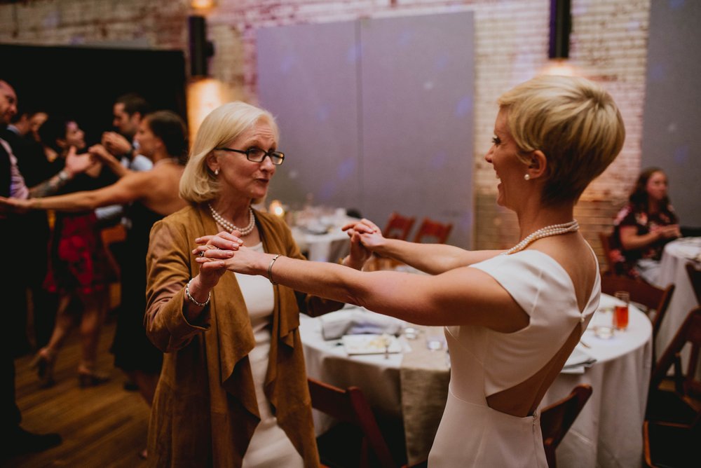 bride and her mother sharing in a dance during the wedding reception