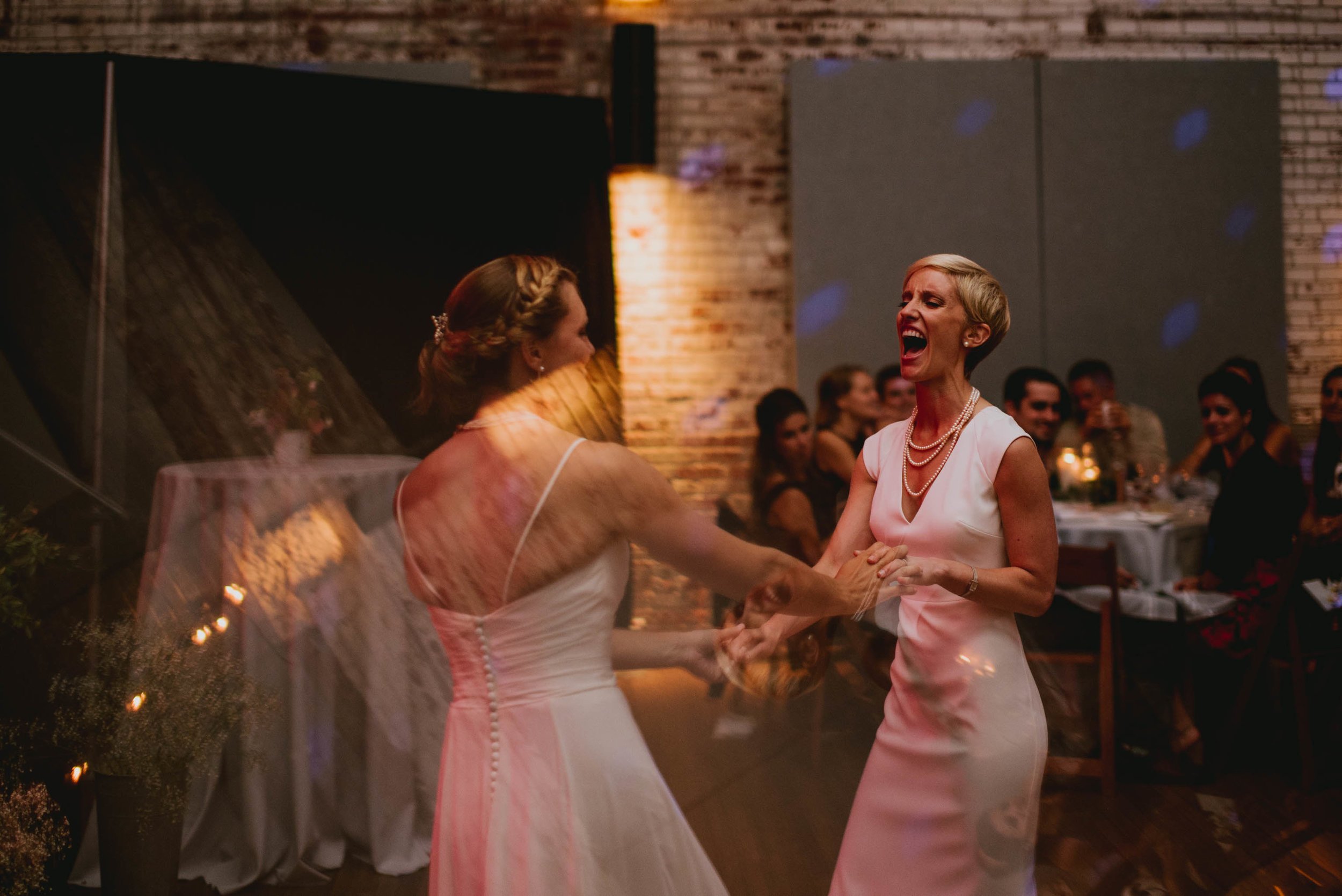 brides enjoying their first dance at the haw river ballroom