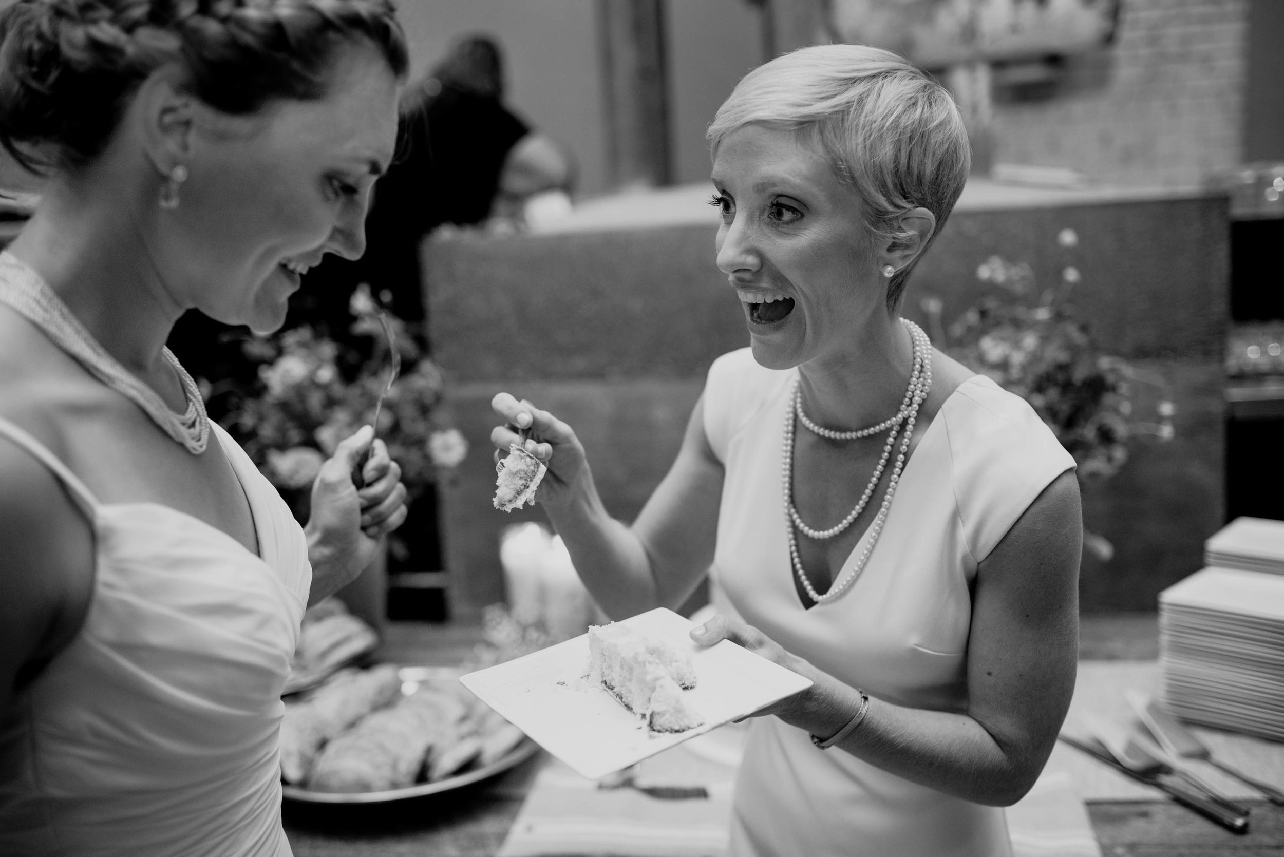 brides enjoying their cake cutting at the haw river ballroom