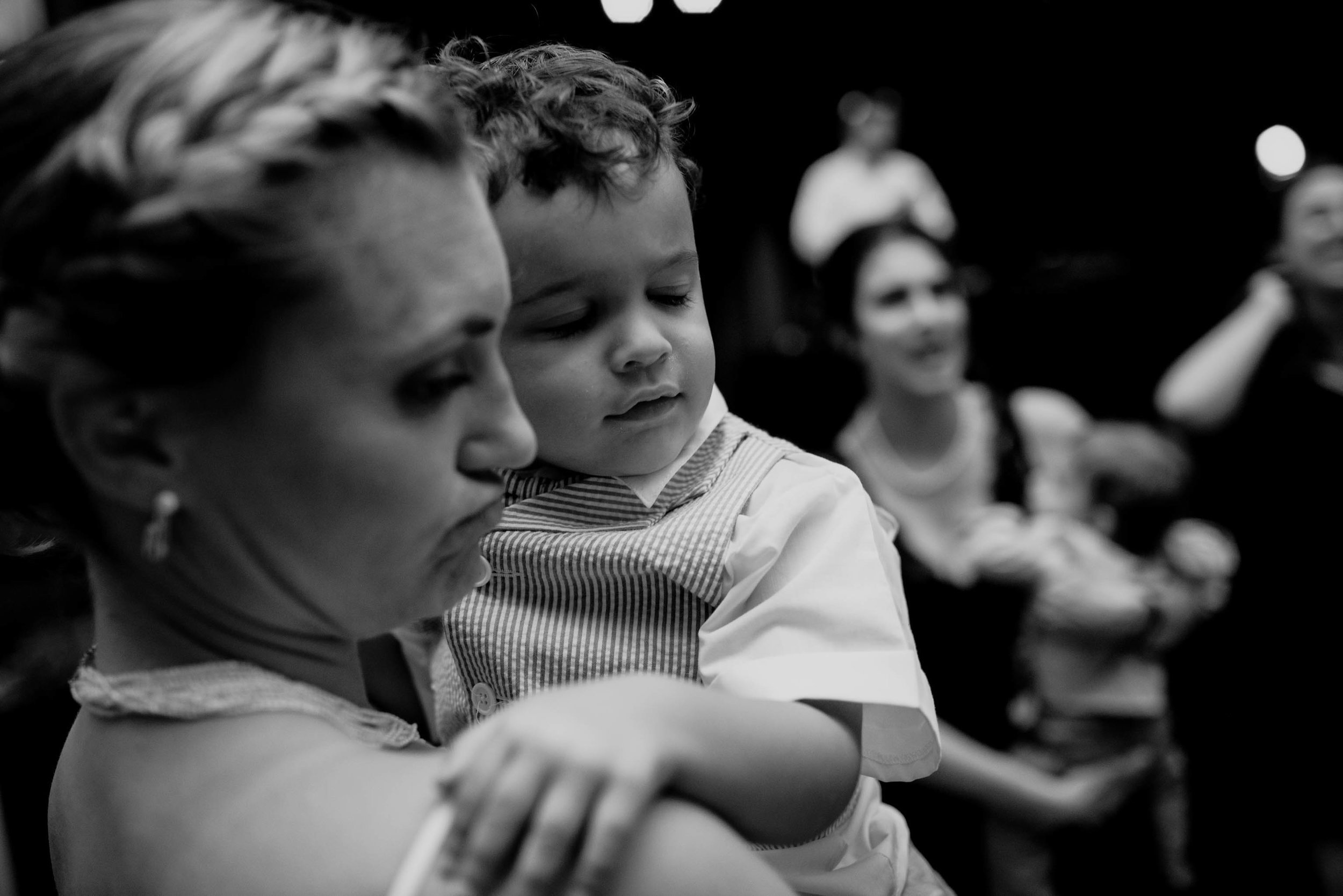 bride holding her nephew during the wedding reception at the haw river ballroom
