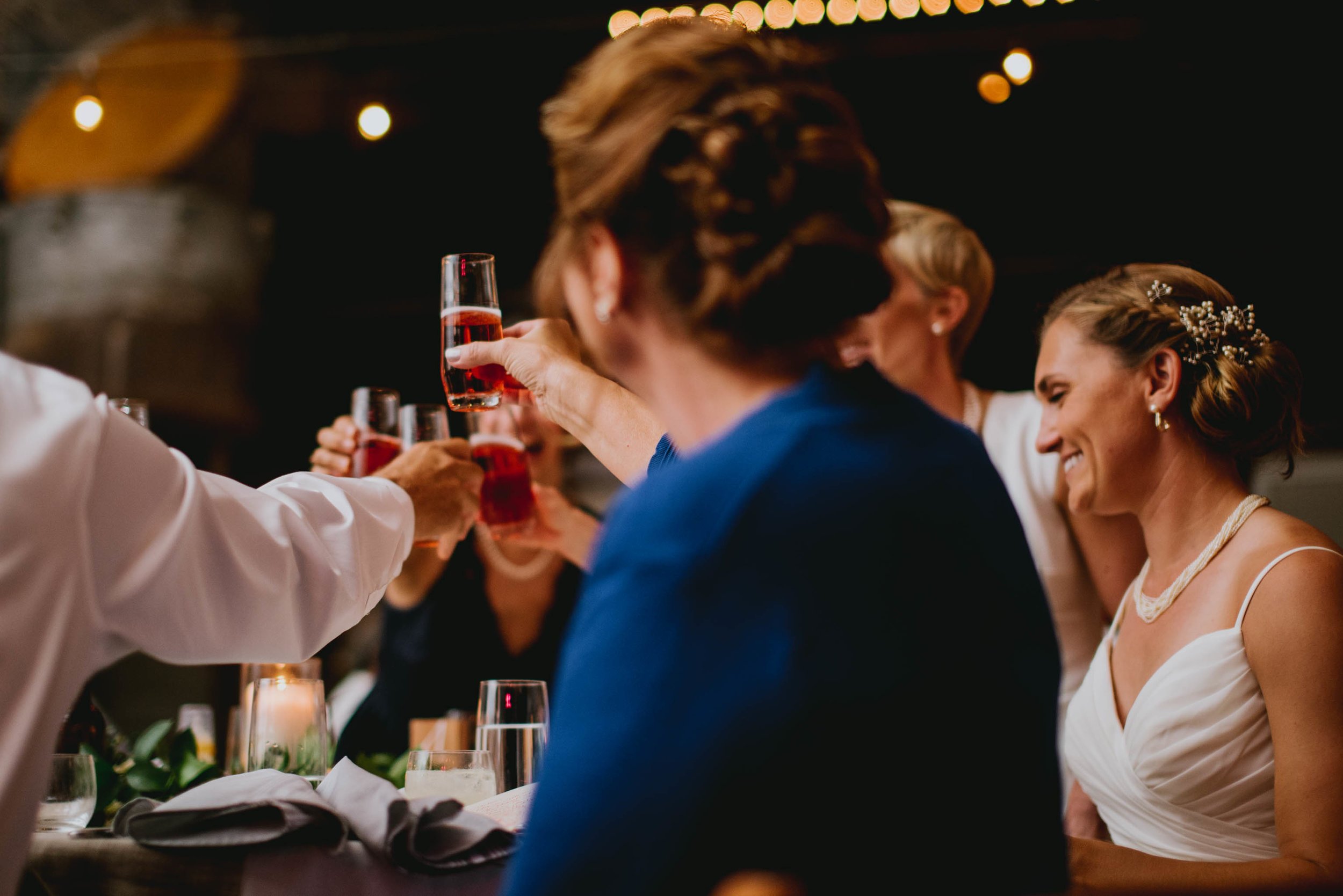 head table sharing in a toast during the wedding reception at haw river ballroom