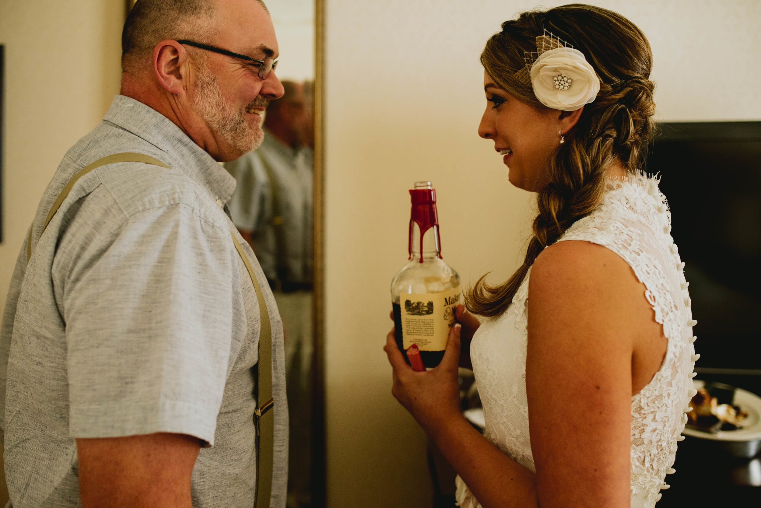 bride suggesting a celebratory shot of whiskey with her dad