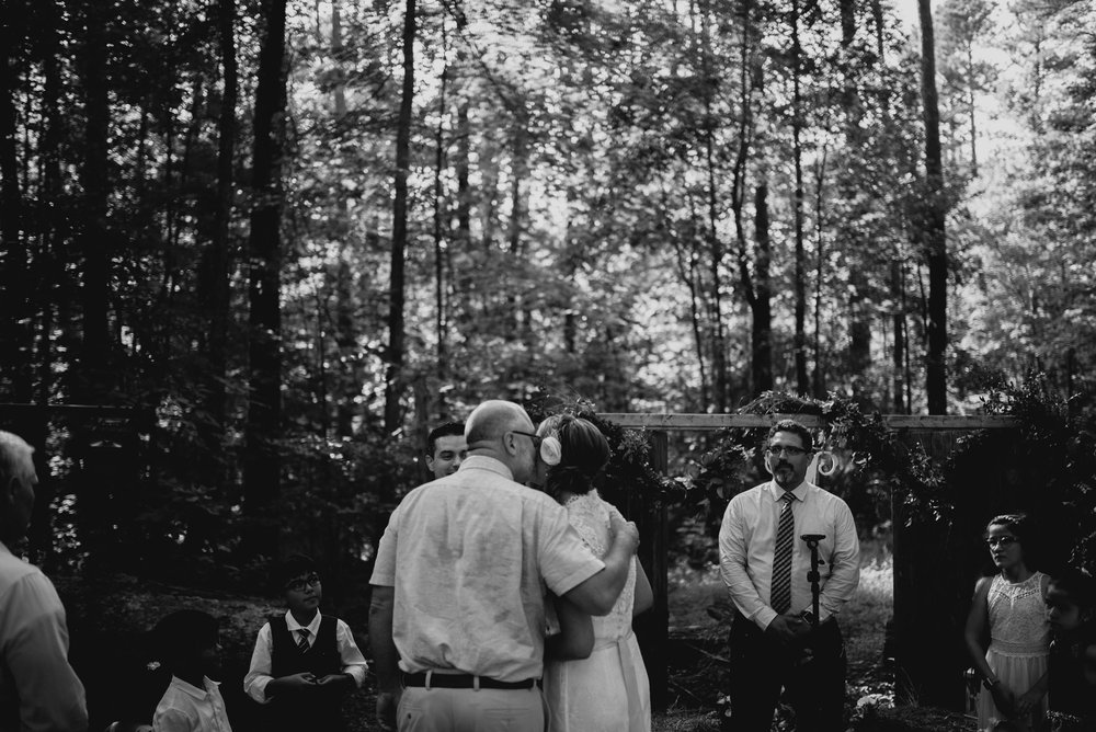 father giving away his daughter during wedding ceremony