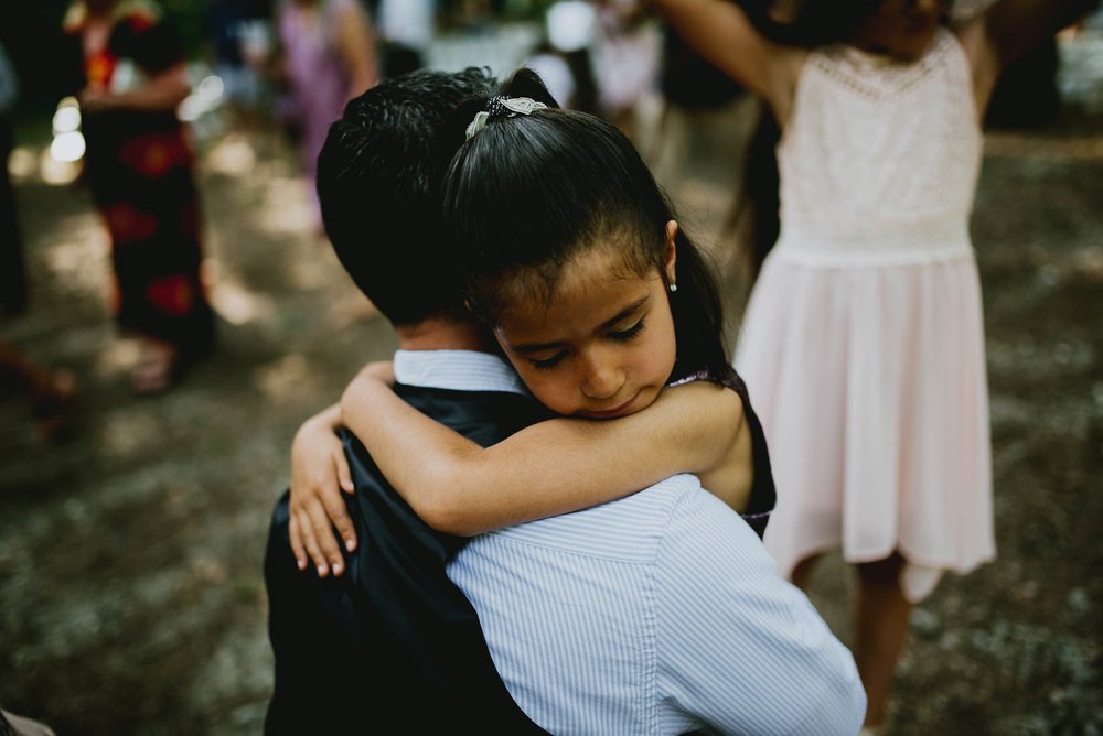 grooms niece giving him a hug after the wedding ceremony