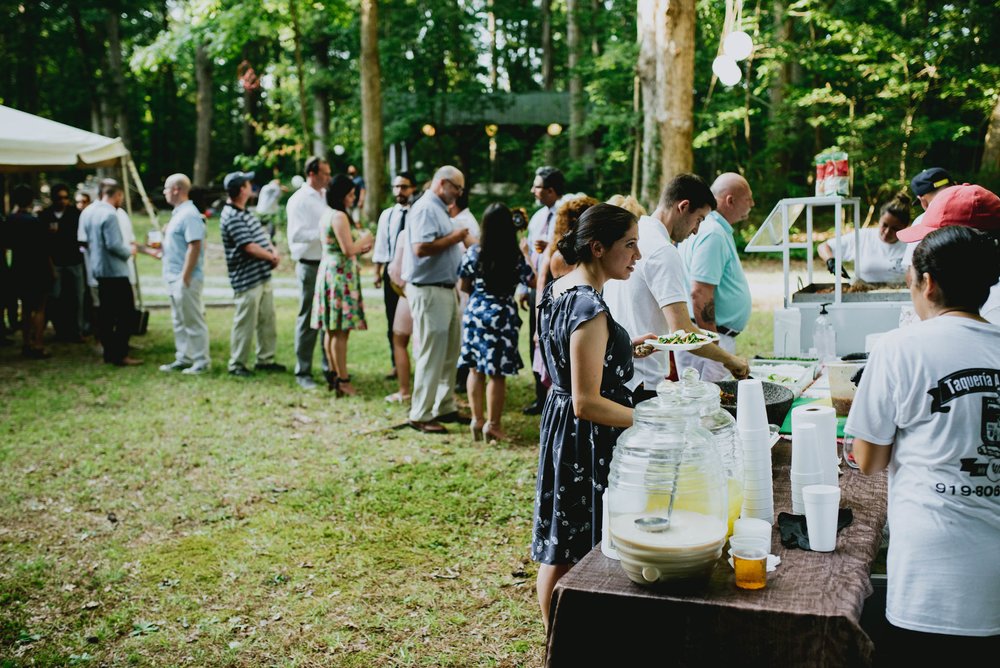 wedding guests line up for tacos
