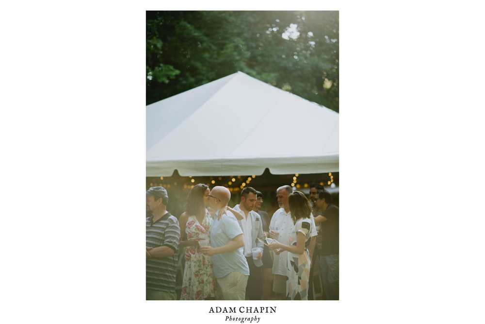 wedding guests share a kiss while waiting in taco line