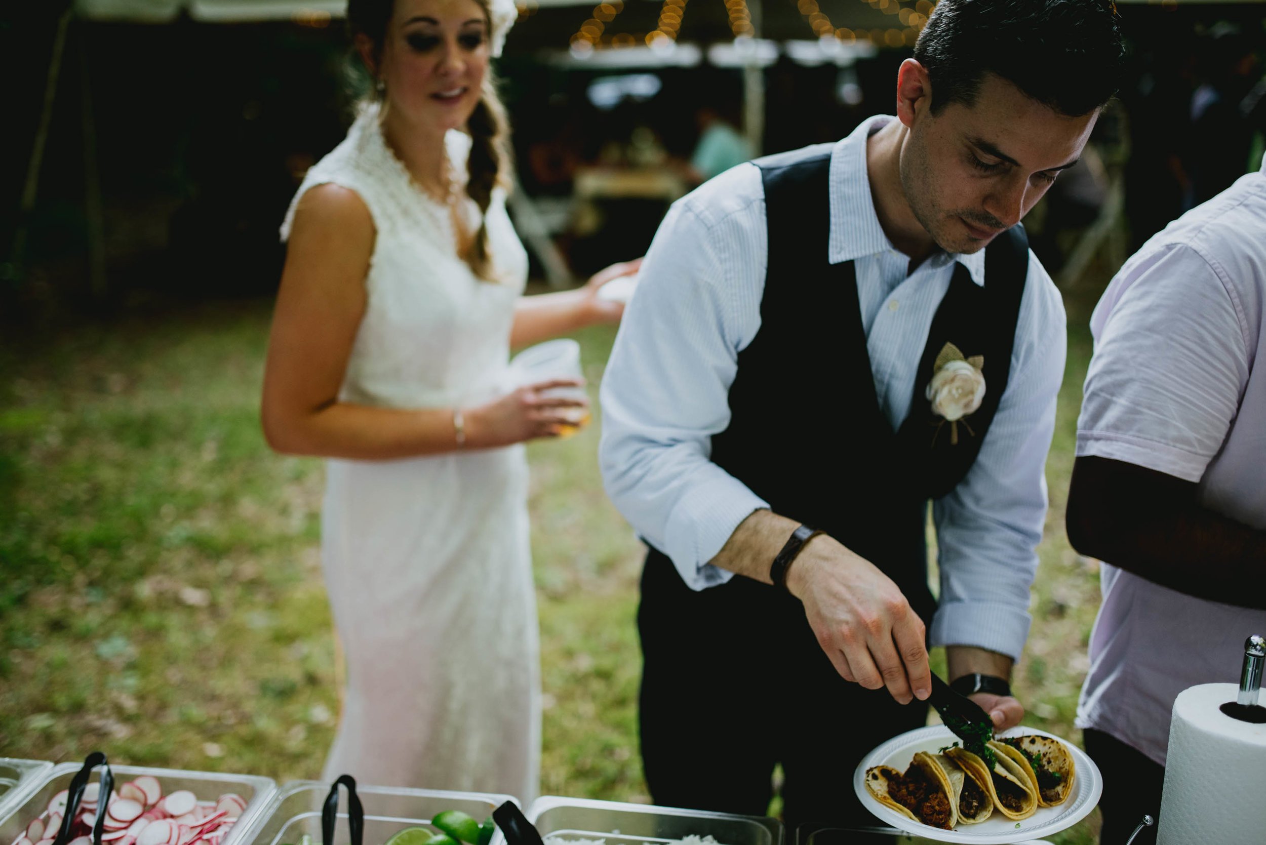 bride and groom getting their taco plates during their wedding reception