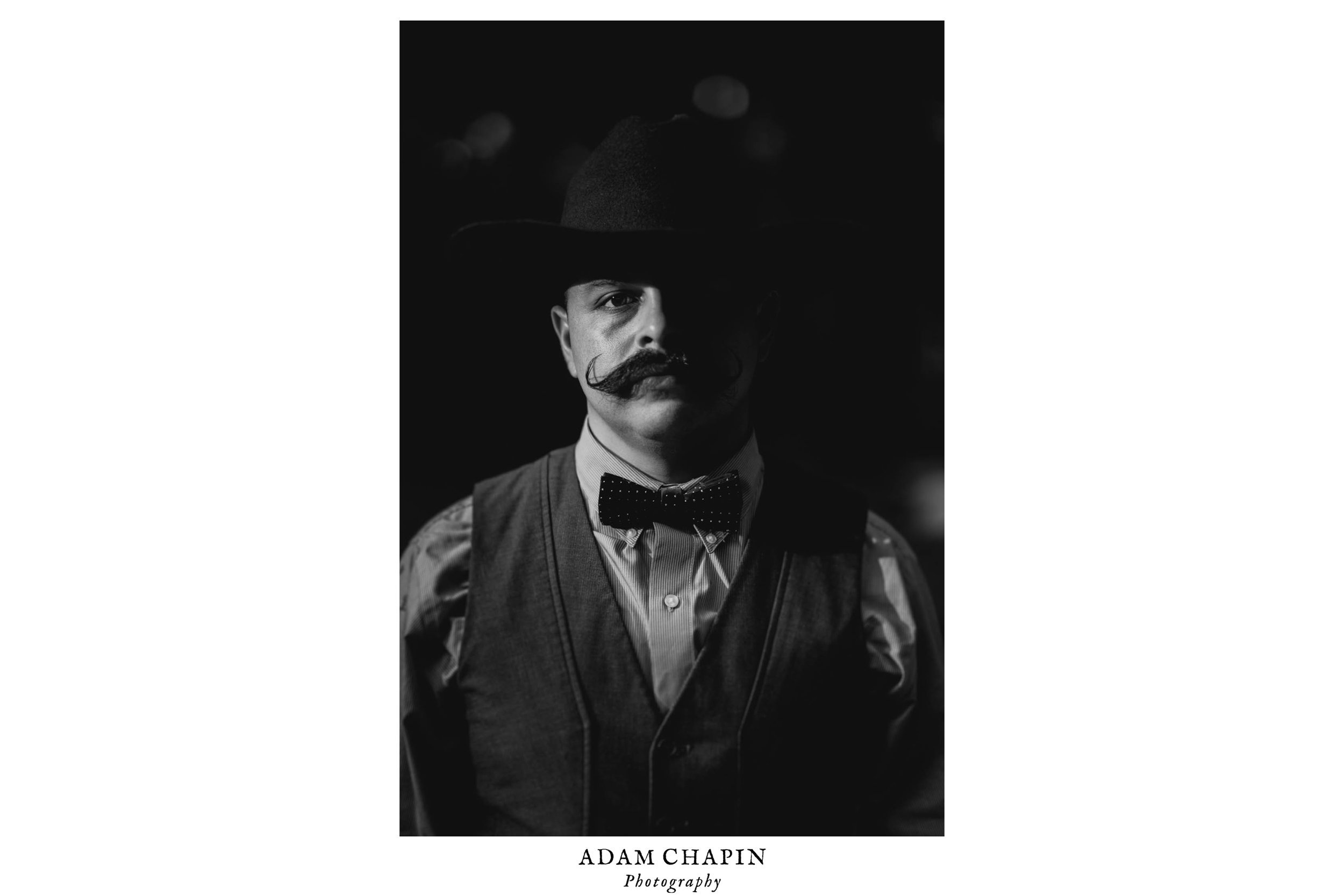 cowboy standing for a portrait during duke forest wedding