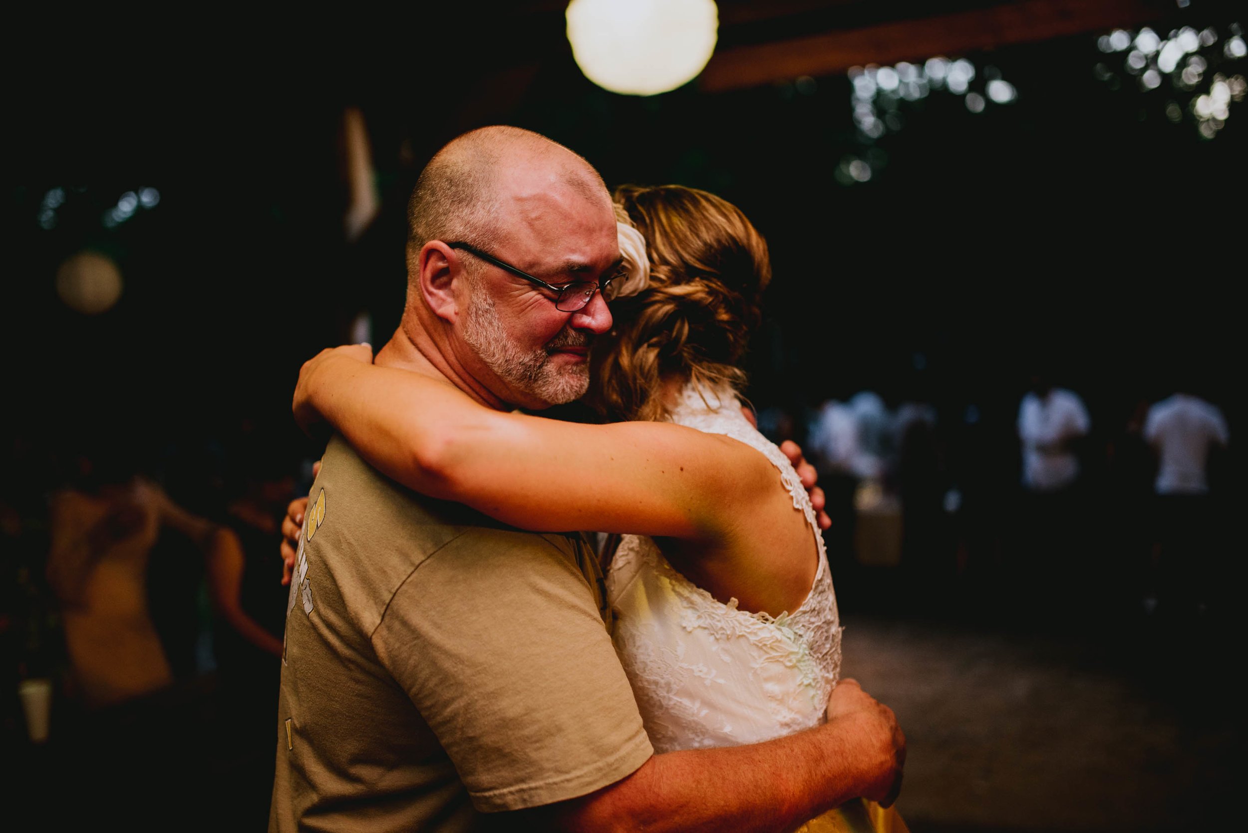 bride and her father embracing during father-daughter dance