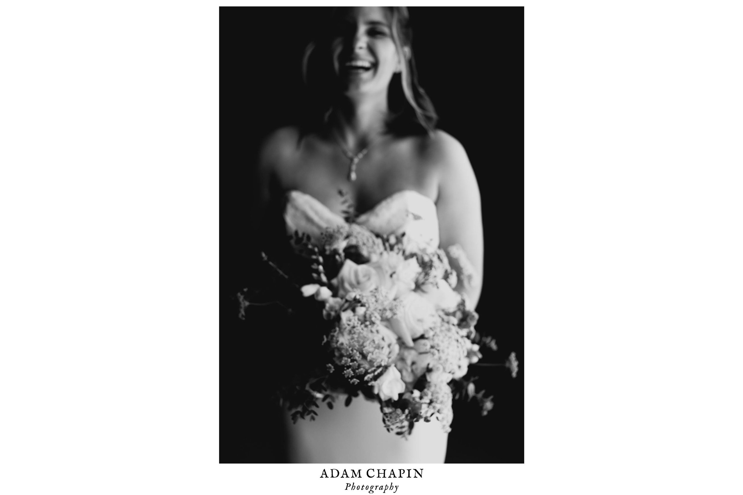 bride laughing while holding bouquet at The Umstead Hotel and Spa