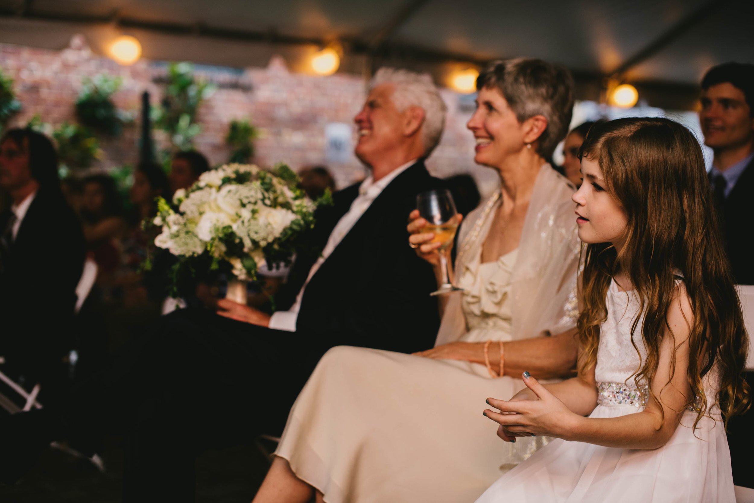 bride's family smiling during the ceremony of their Jiddi Space and Courtyard Wedding at Sitti Restaurant