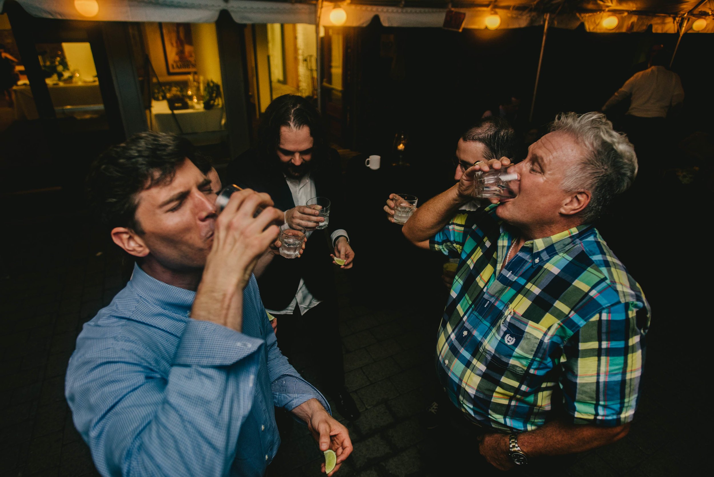 groom and guests taking tequila shot during their Jiddi Space and Courtyard Wedding at Sitti Restaurant