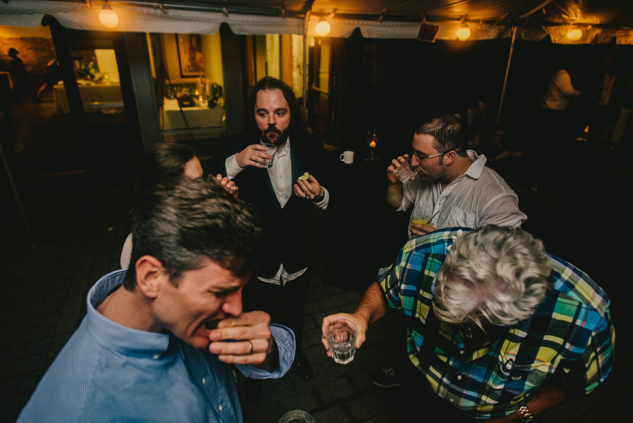 groom and guests taking tequila shot during their Jiddi Space and Courtyard Wedding at Sitti Restaurant