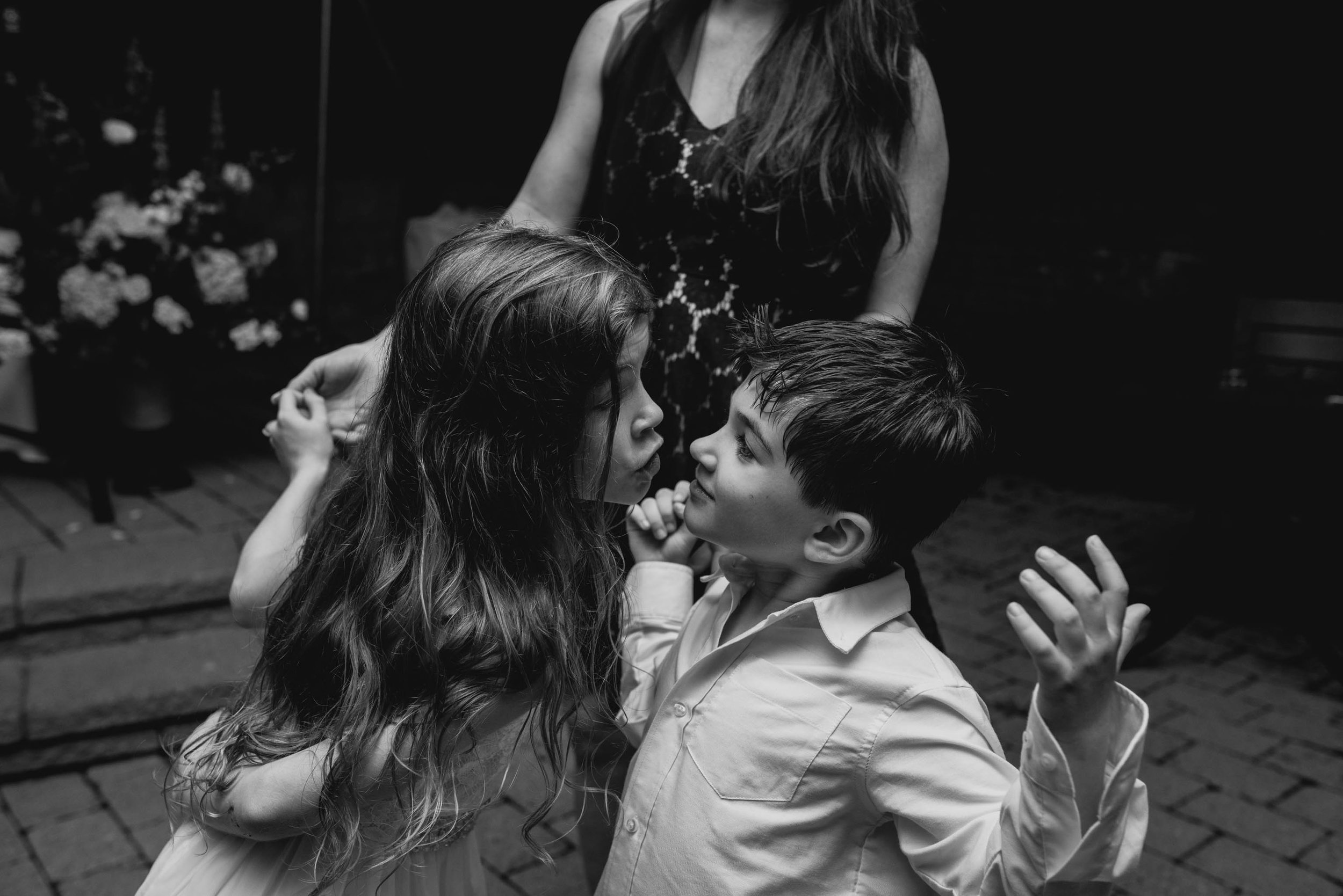 ring bearer and flower girl facing off during reception at this Jiddi Space and Courtyard Wedding at Sitti Restaurant