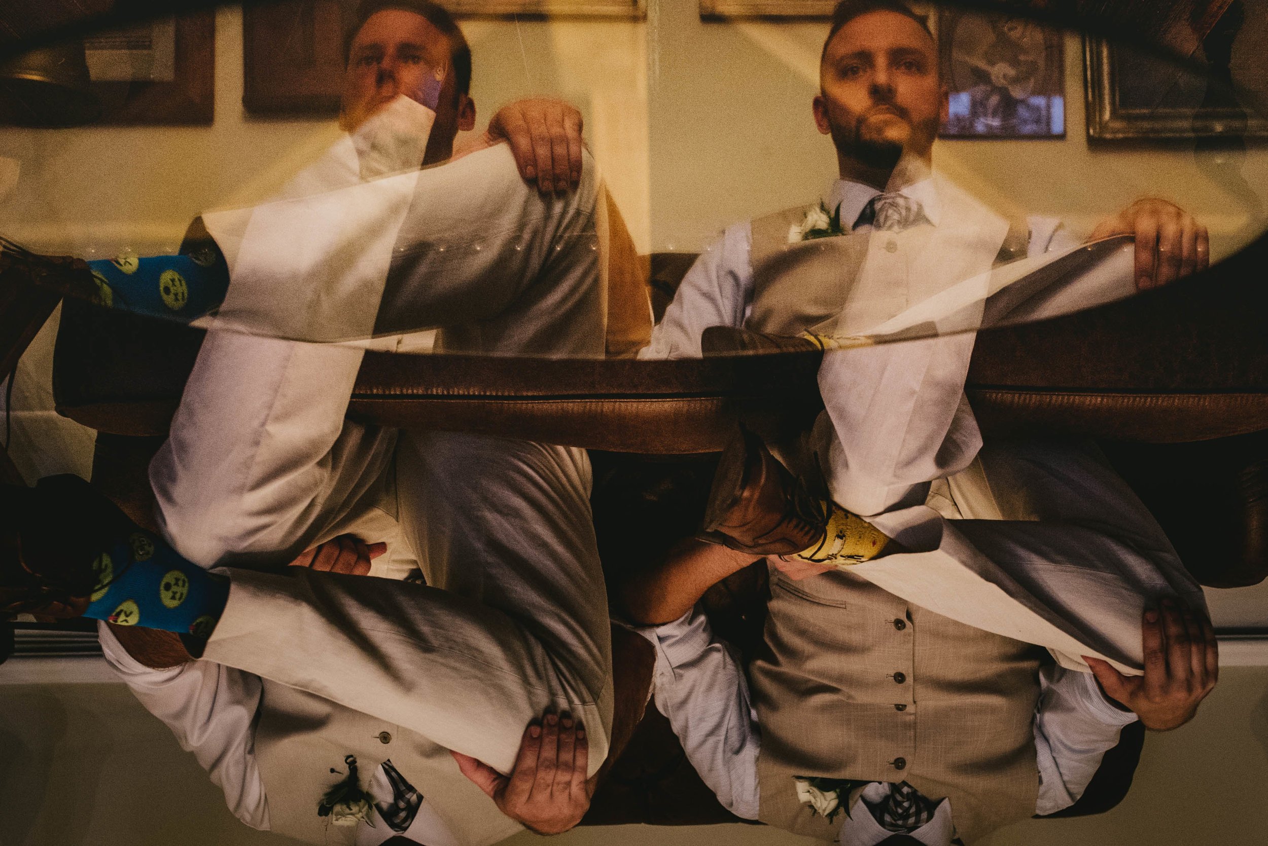 reflective portrait of groom and best man before mims house wedding