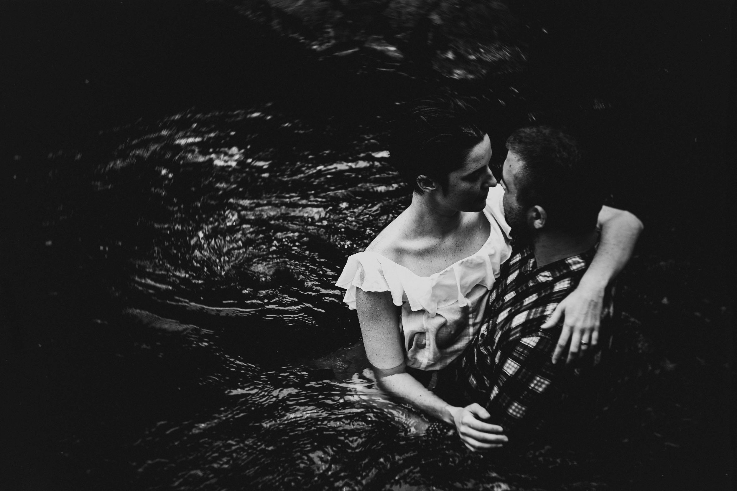 Couple embracing in the Eno River during their Durham engagement photos