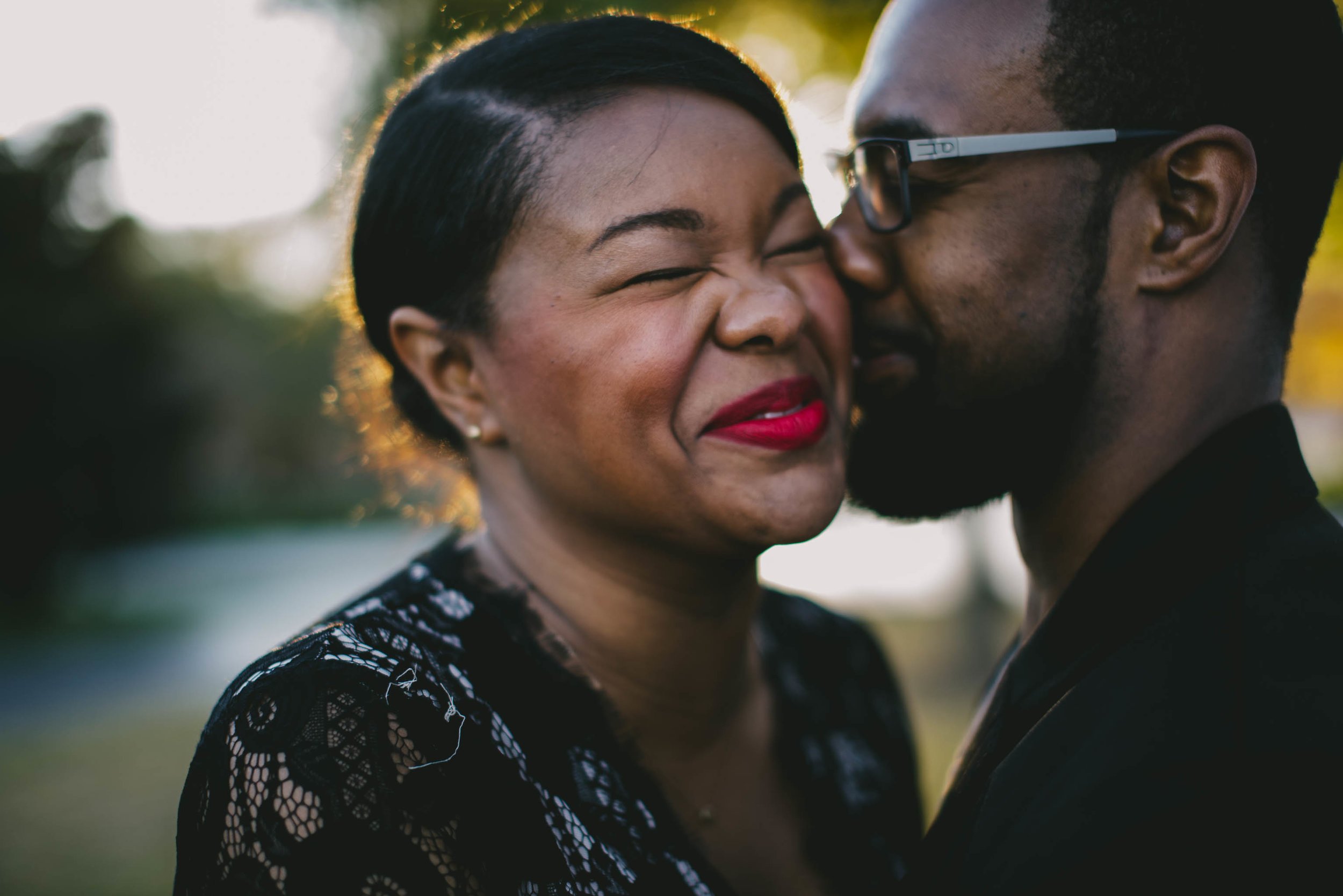 Couple laughing during engagement photos at North Carolina Museum of Art