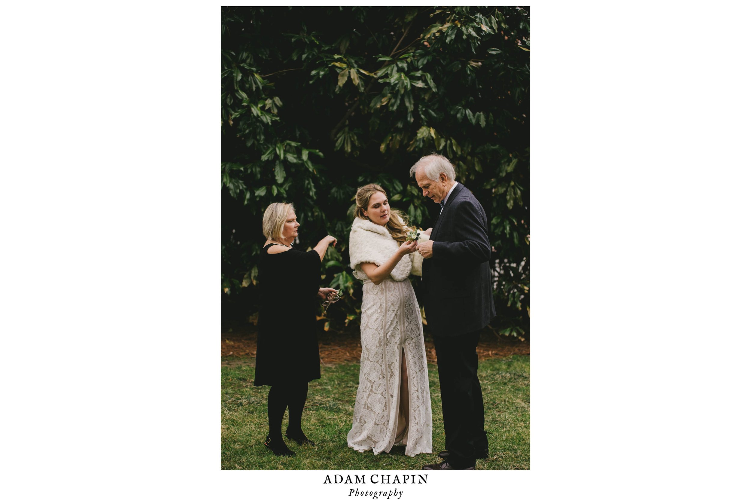 the bride fixing her dads suit before family portraits