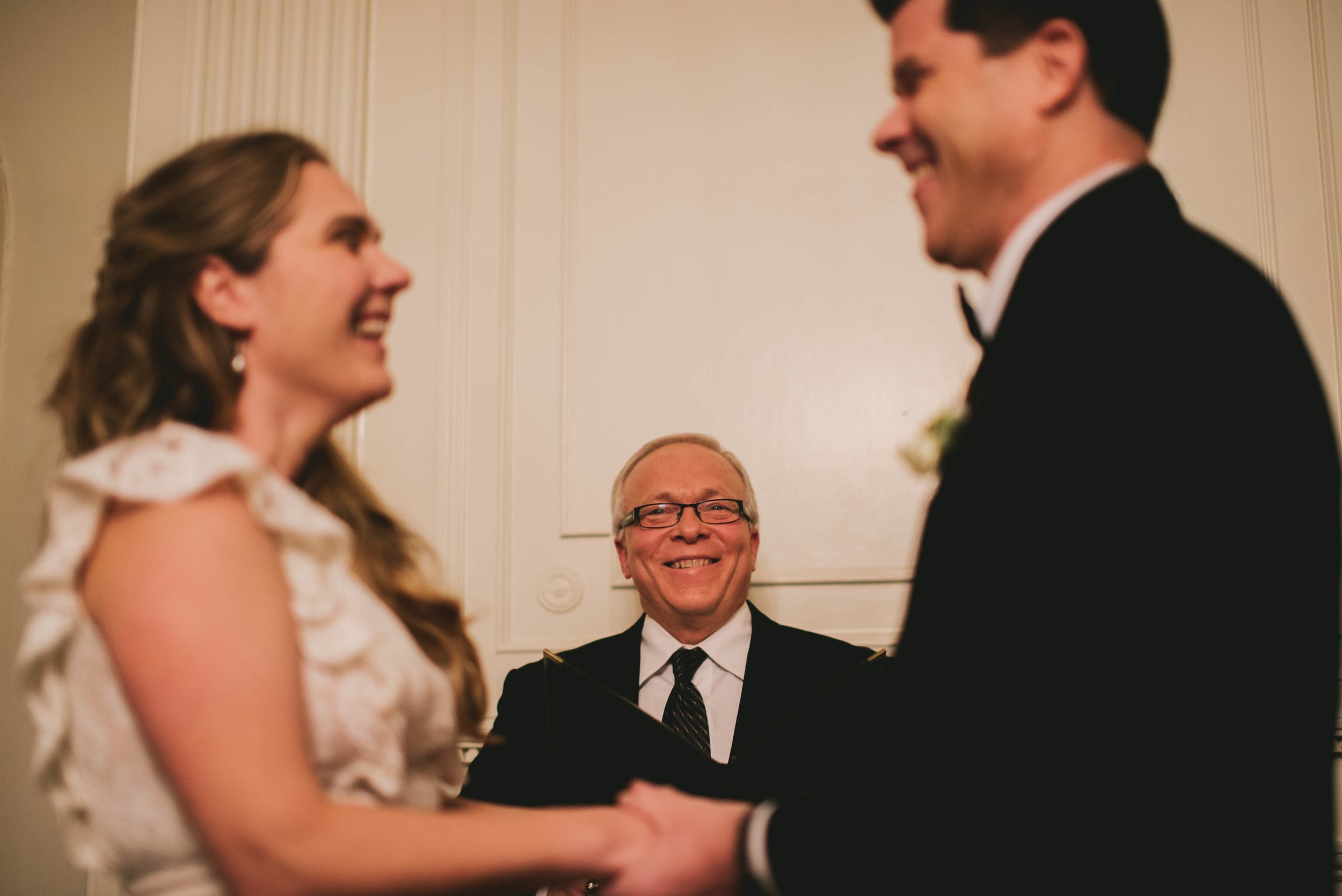 the bride, groom and officiant laughing during this Carolina Inn wedding ceremony