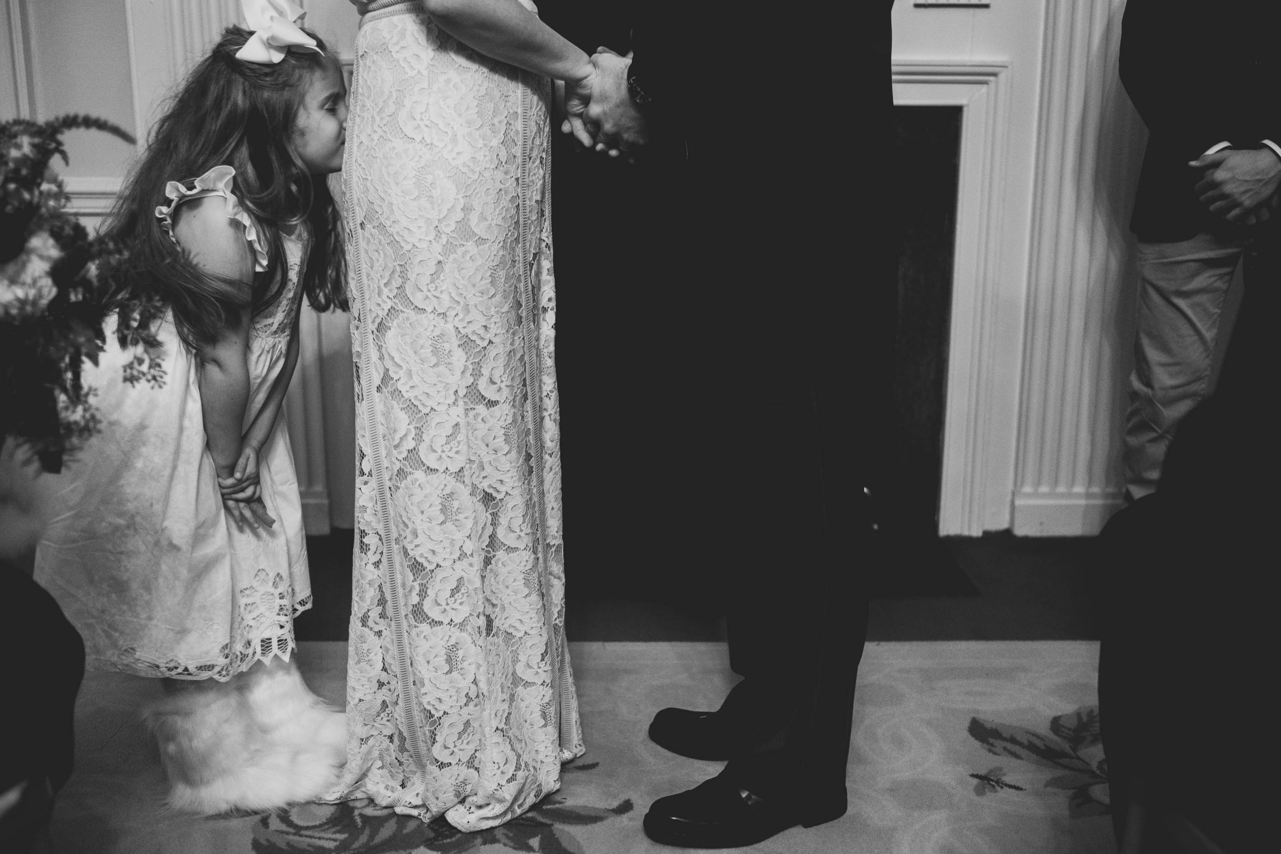 the brides daughter kissing the brides rear end during the ceremony