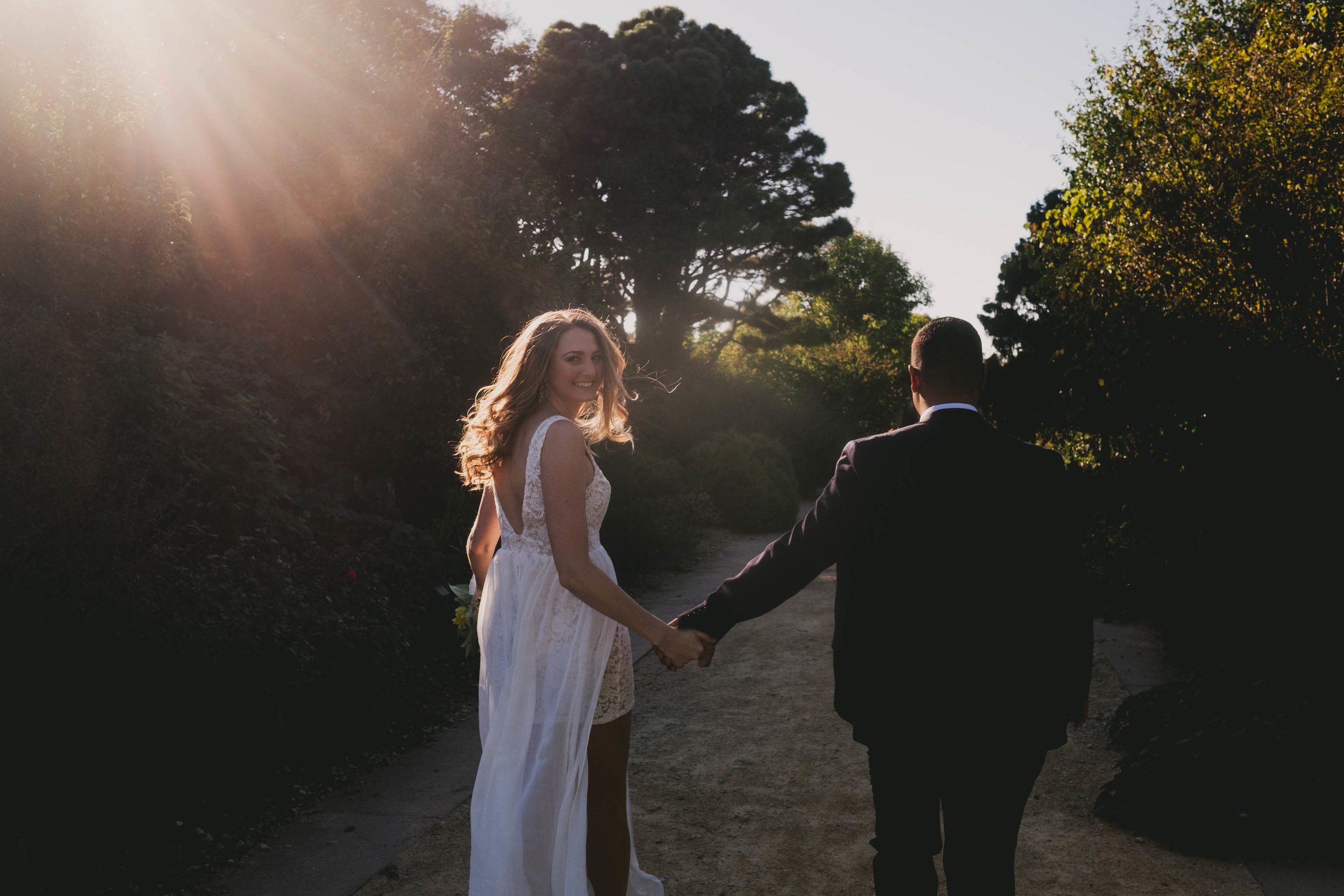 bride-and-groom-run-off-into-sunset-photo.jpg