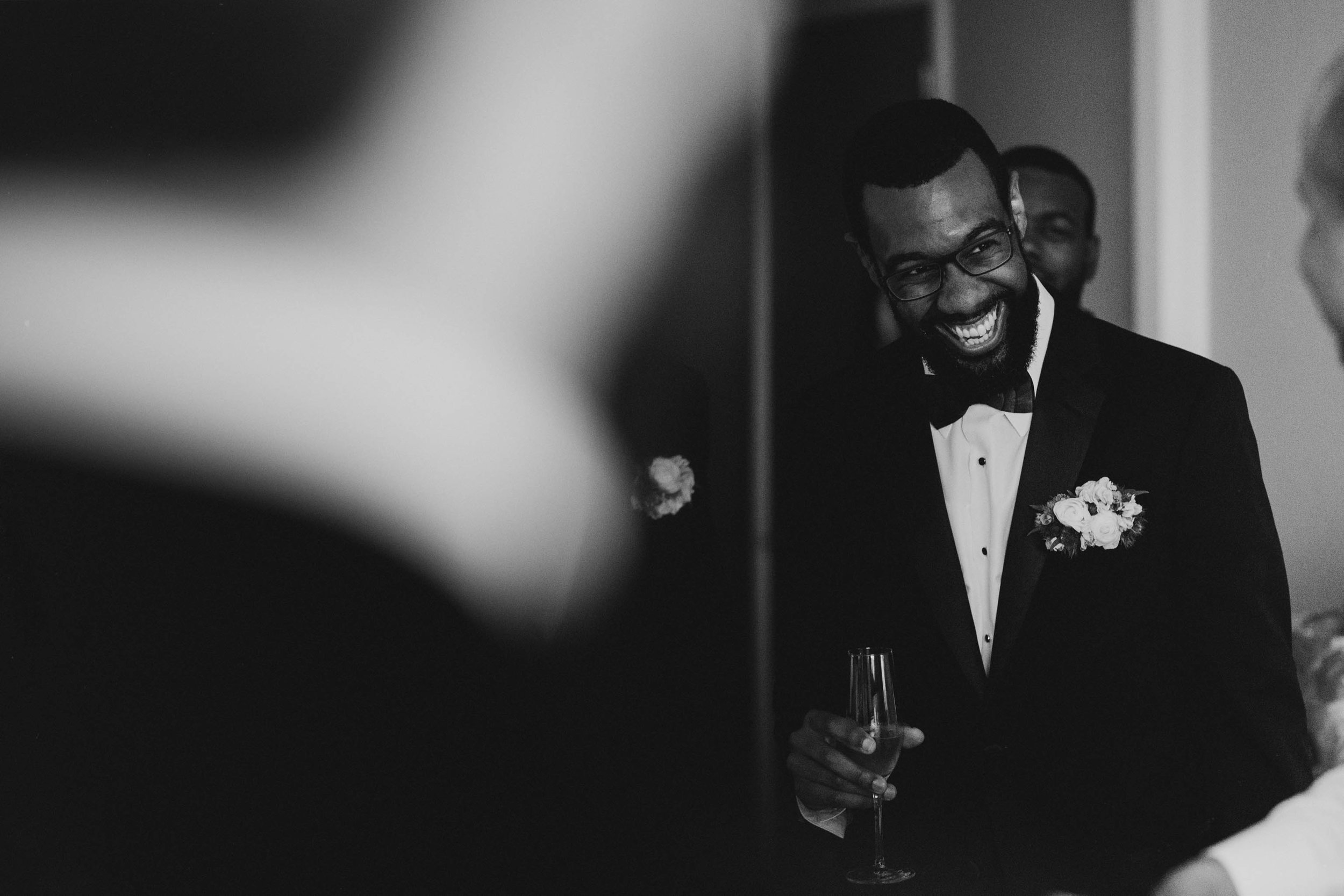 groom laughing with his groomsmen before his wedding at The Umstead Hotel and Spa