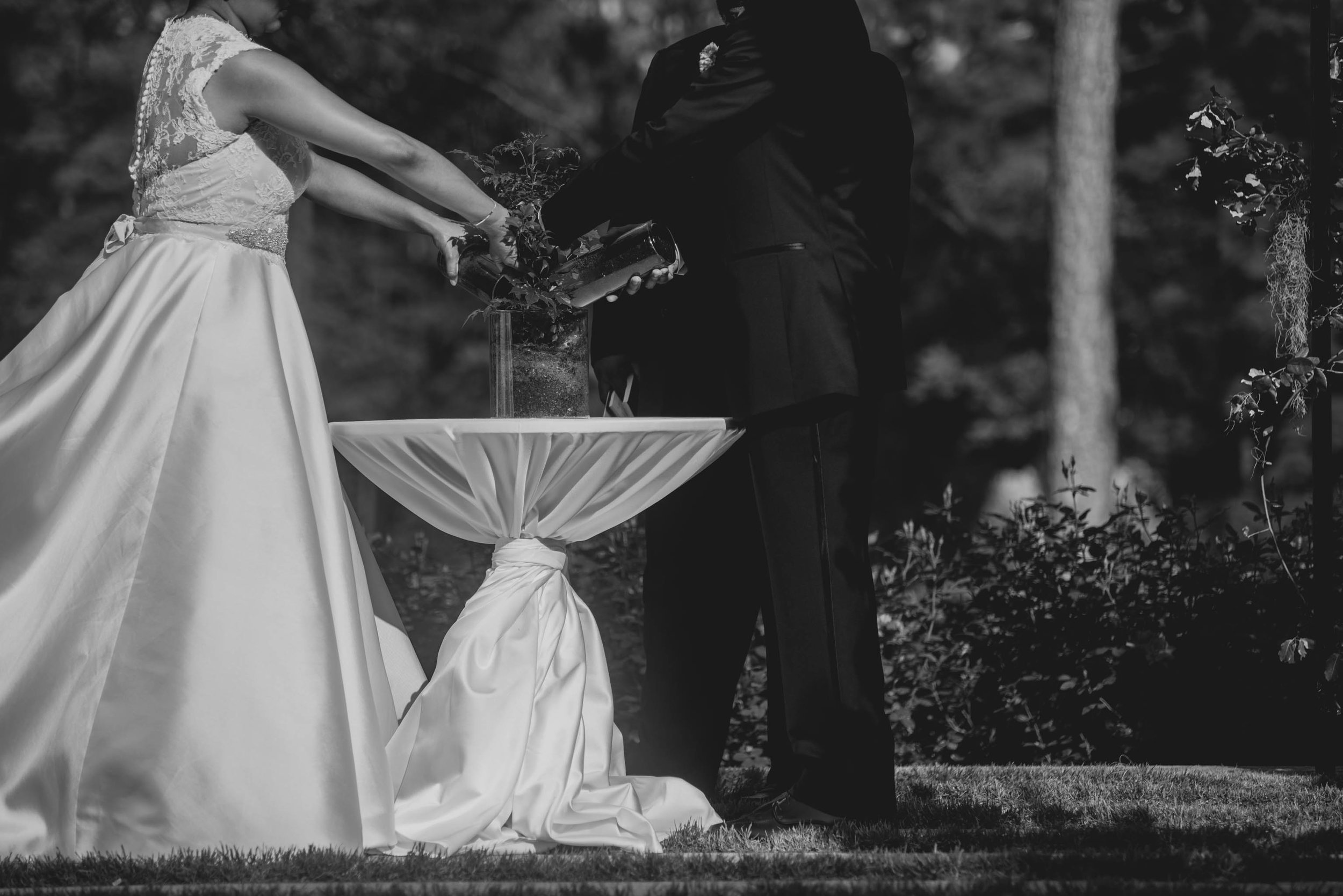 The bride and Groom participating in a tree planting ceremony during their wedding ceremony at the Umstead Hotel and Spa