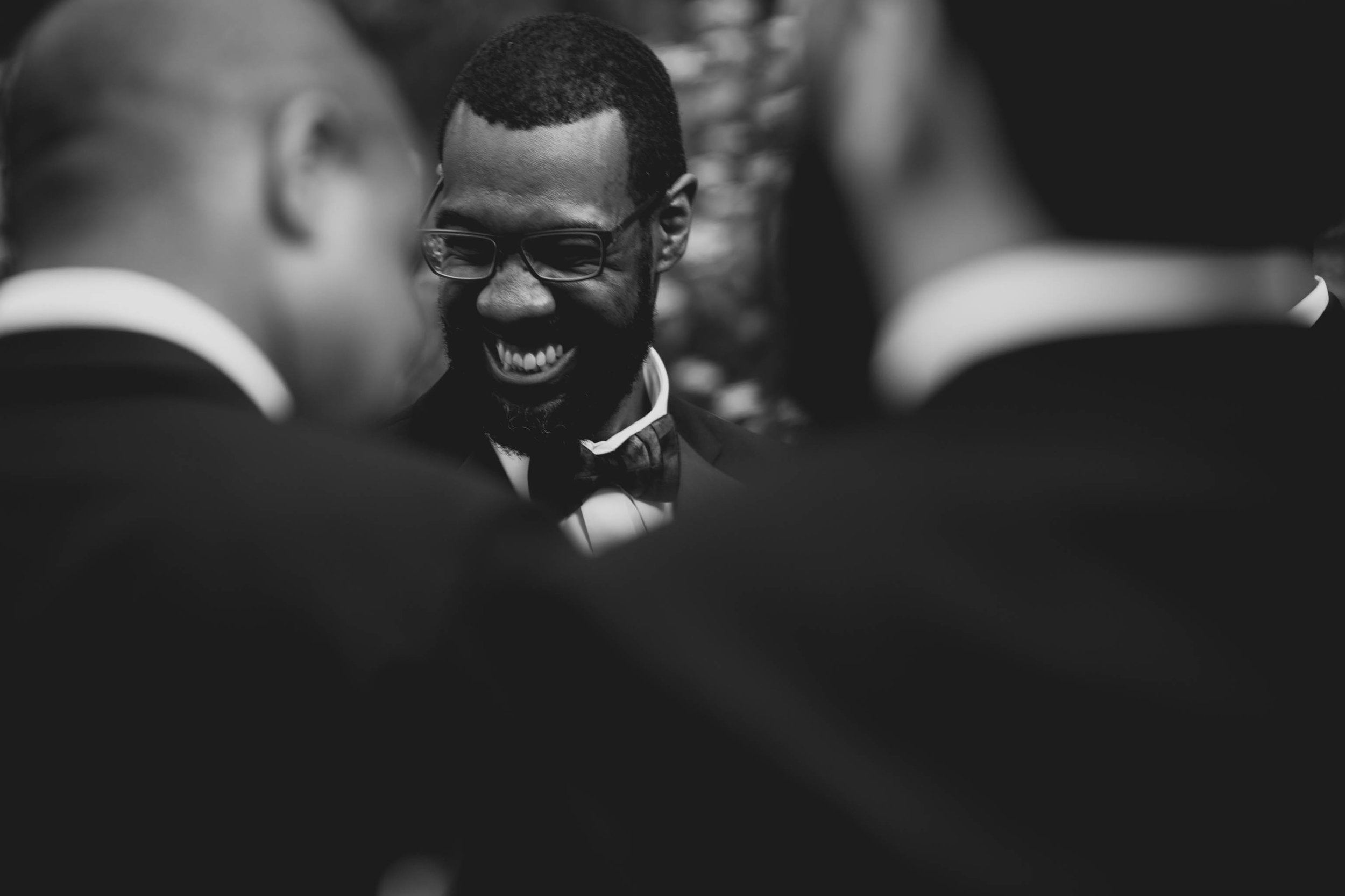 The groom and groomsmen sharing a laugh after the ceremony