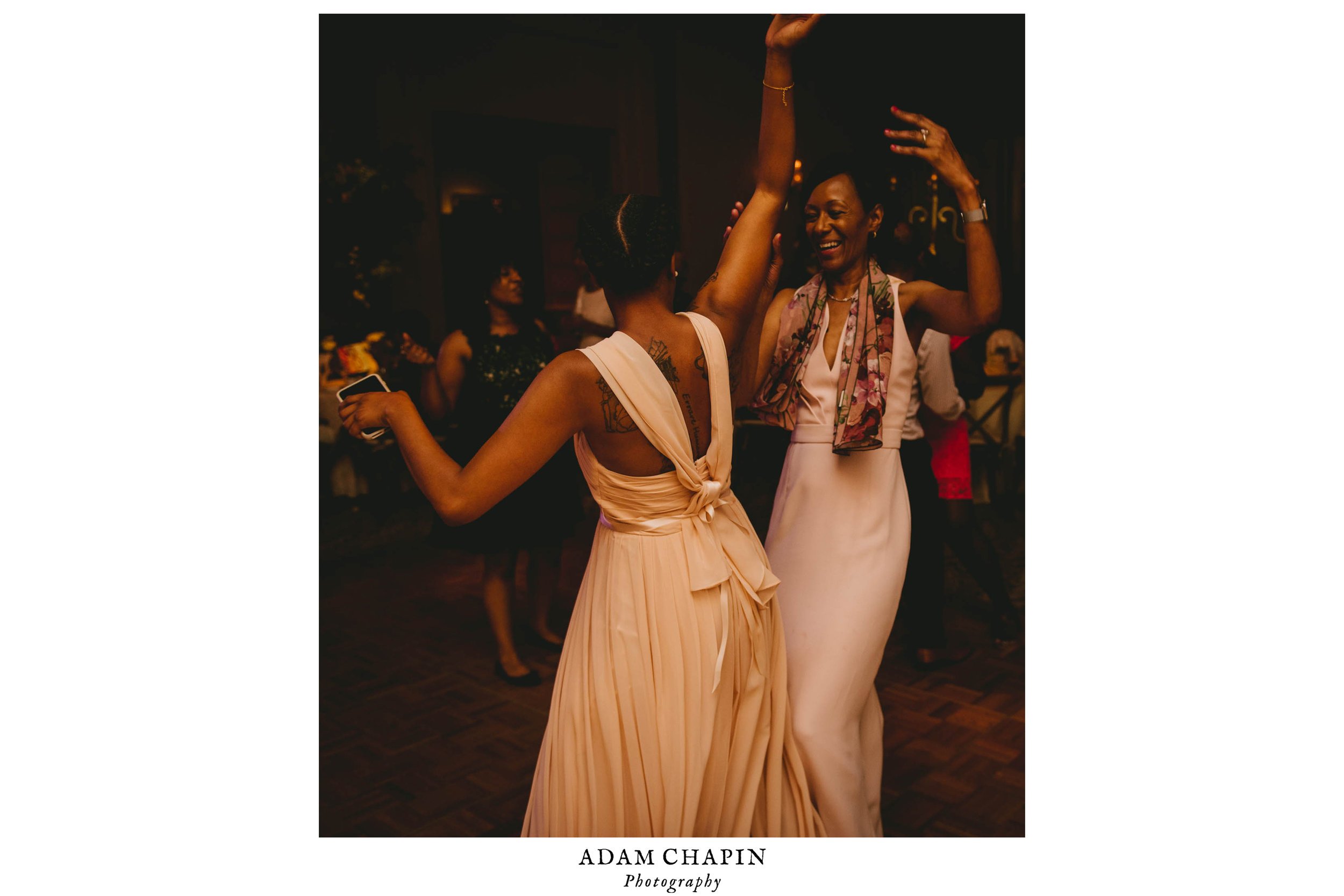 The brides sister and mother dancing during this Raleigh wedding