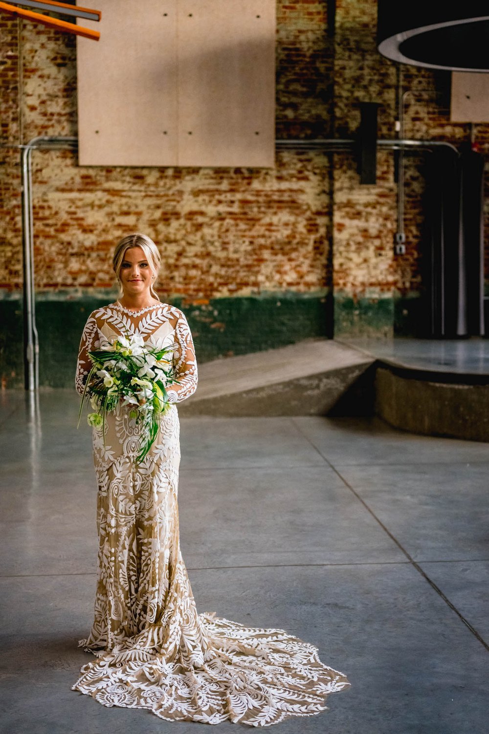 bride stands with her bouquet