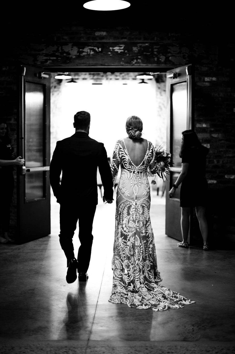 bride and groom walk off through doorway after ceremony