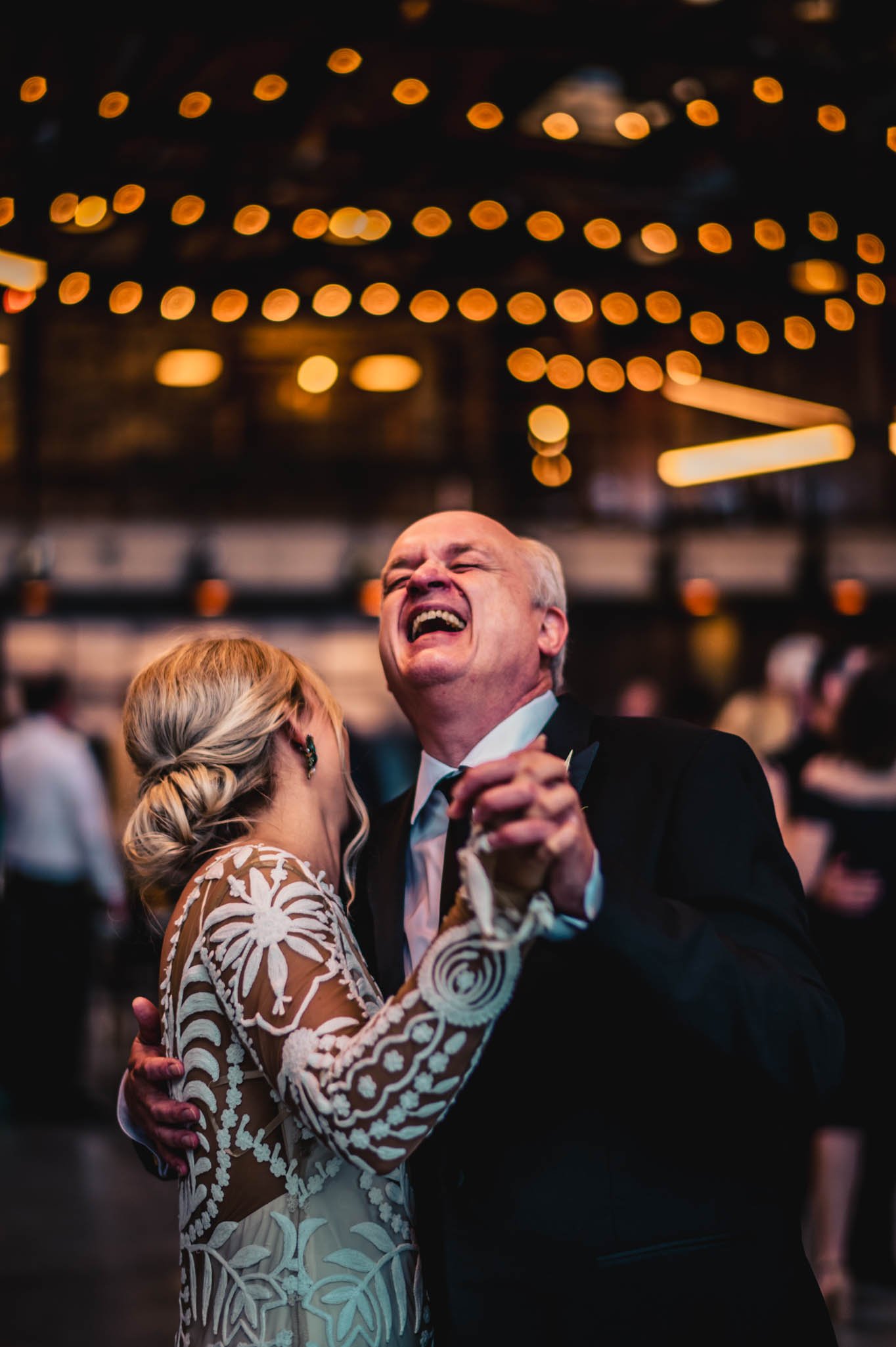 father of the bride sings out as he dances with the bride