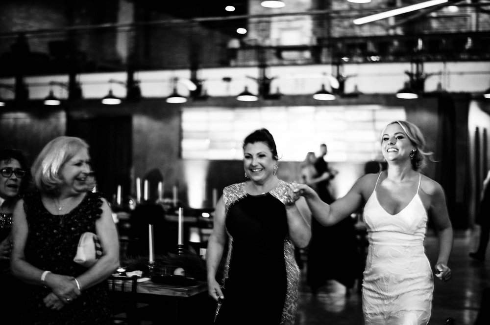 mother of the bride and the bride come out to dance together during the reception