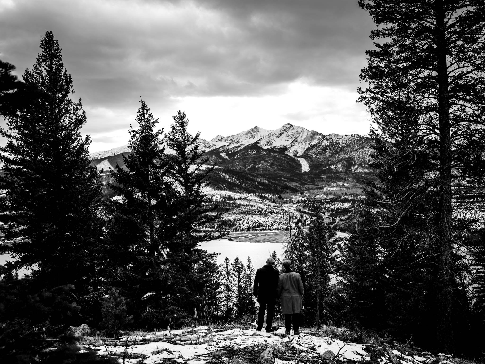 couple looking out into the Rocky Mountains at sunset