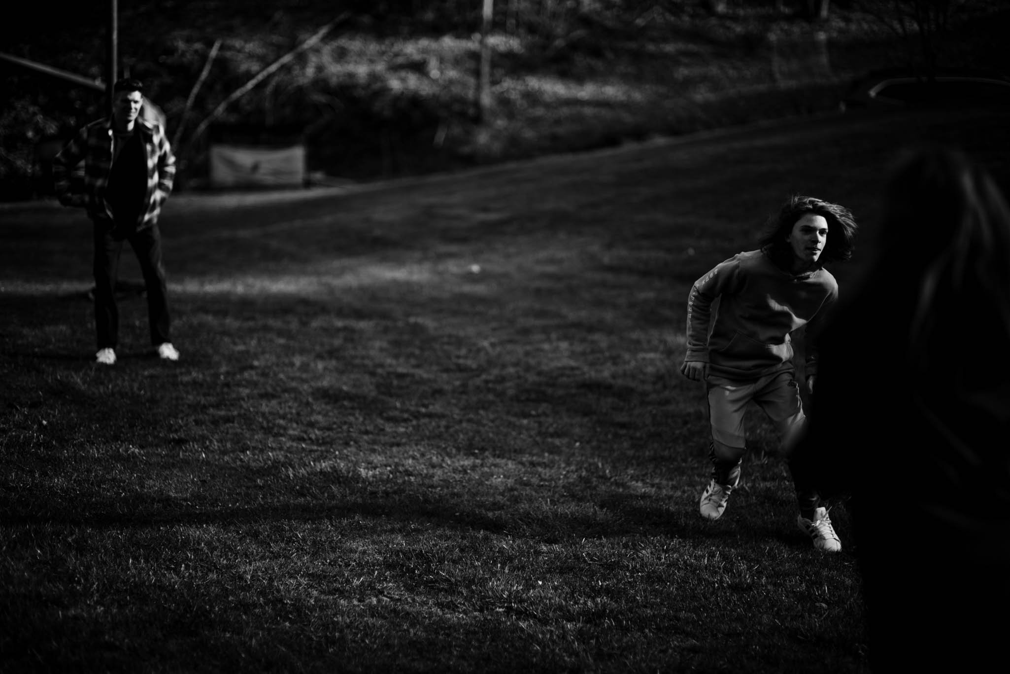 father and son playing defense in a game of football
