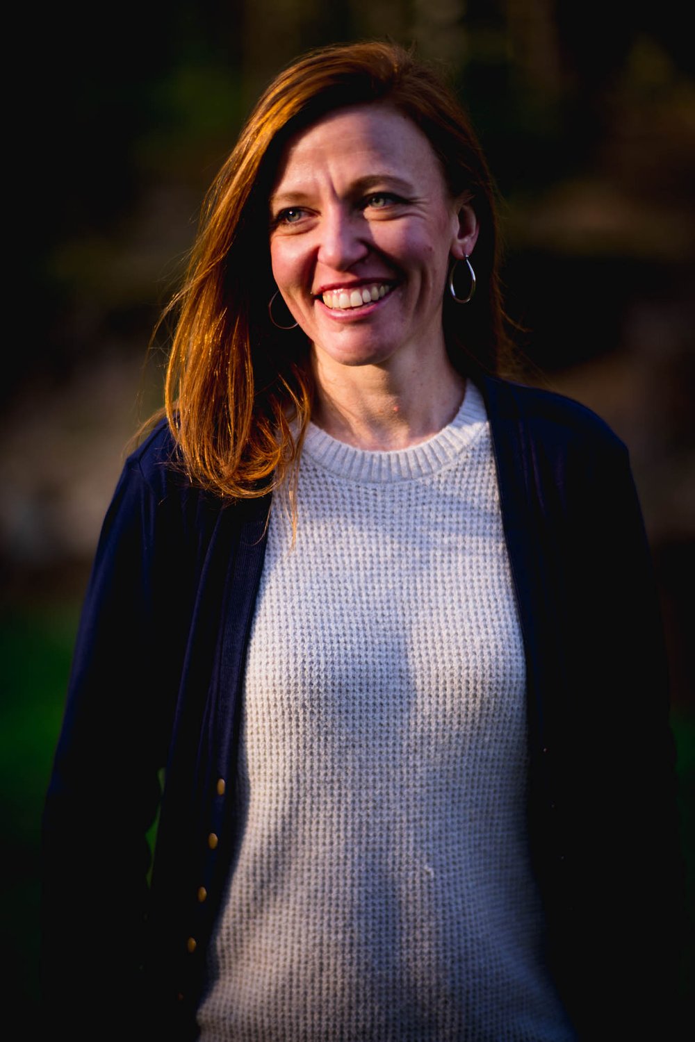 woman smiling in the glow of the sunset