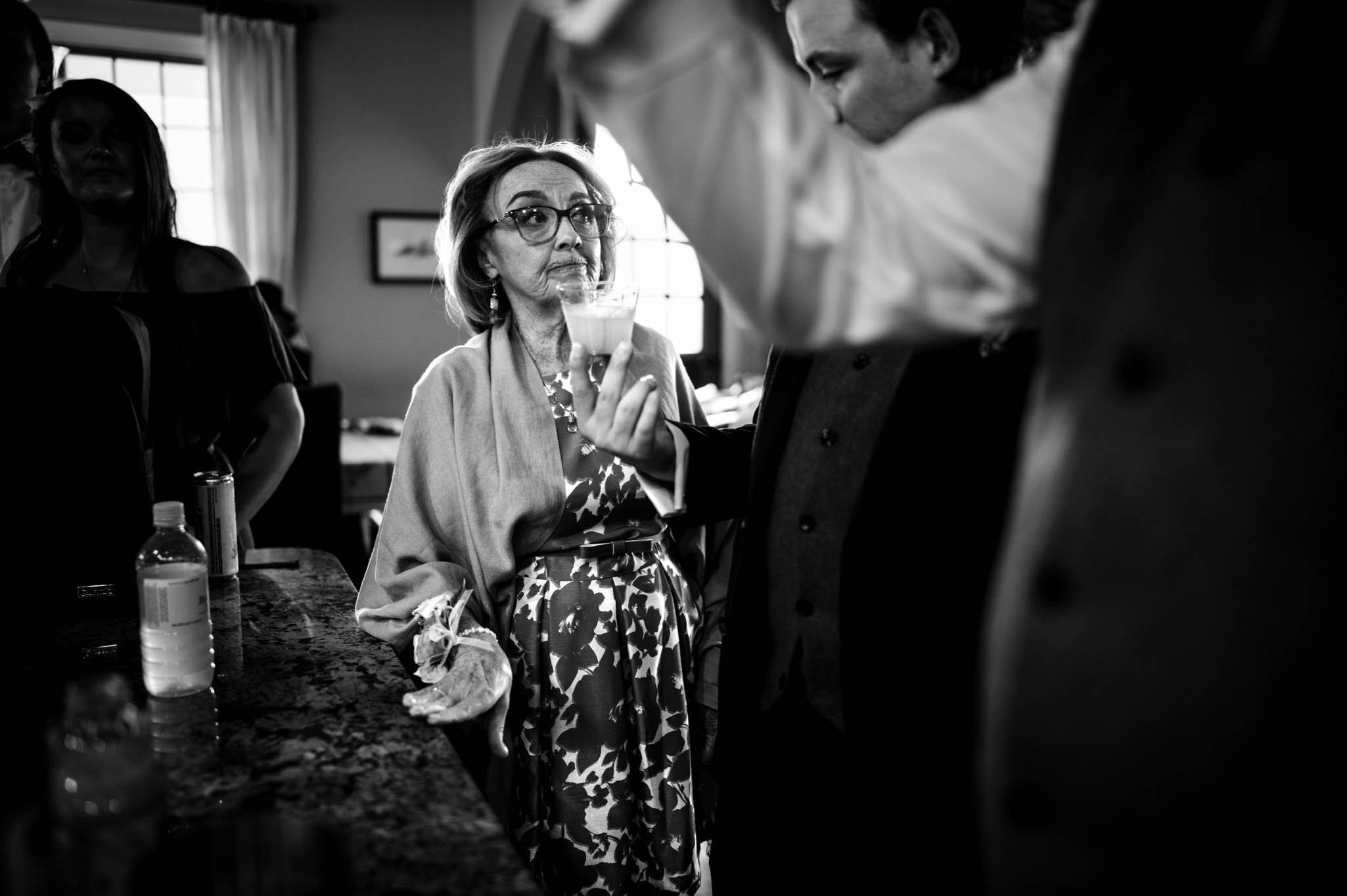 mother of the groom watches on as cocktails are made