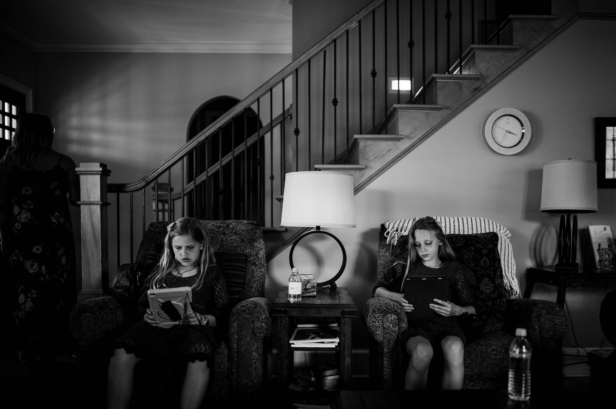two girls play on their ipads before the wedding