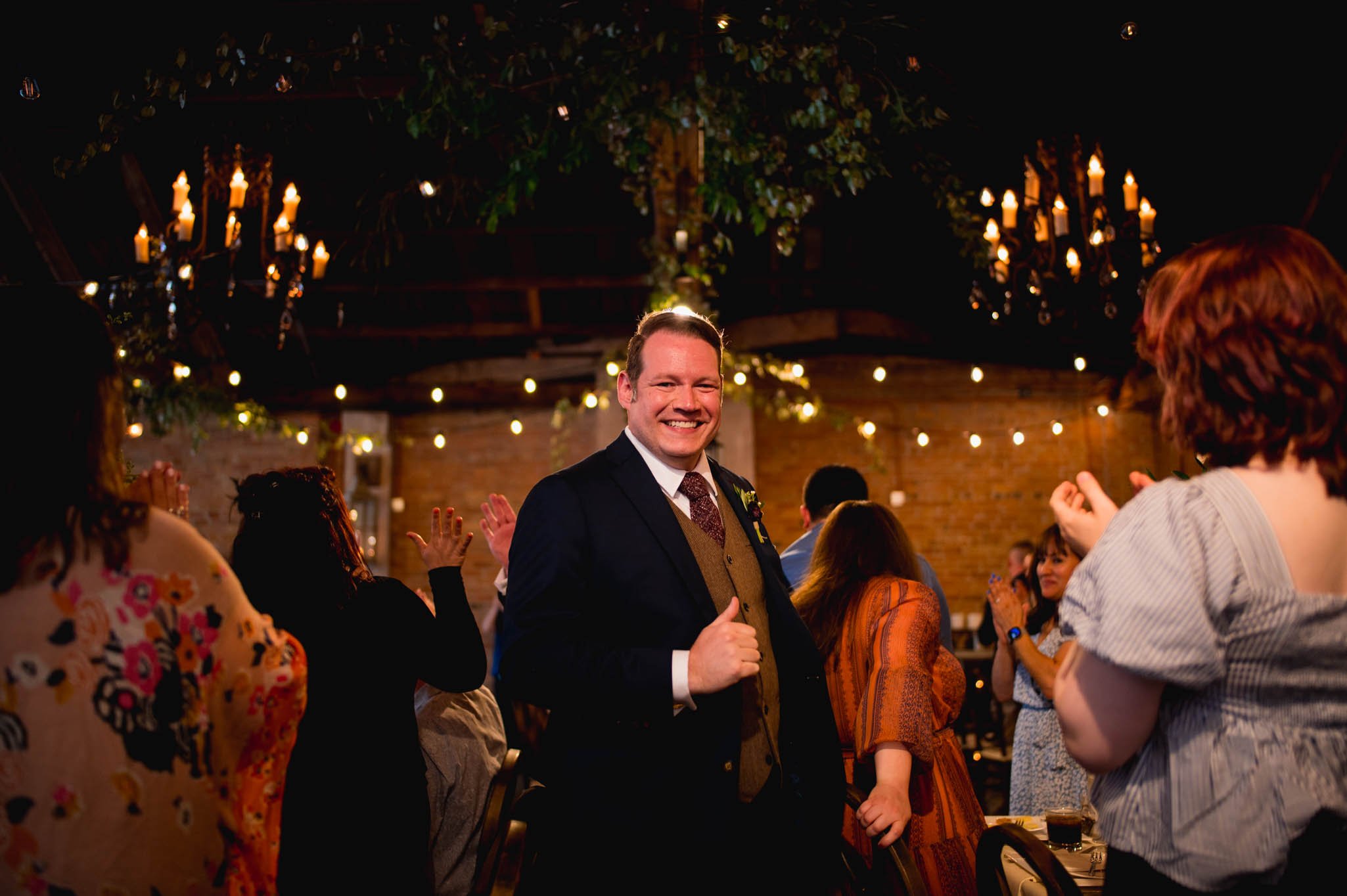 a groom joins the reception with big smiles