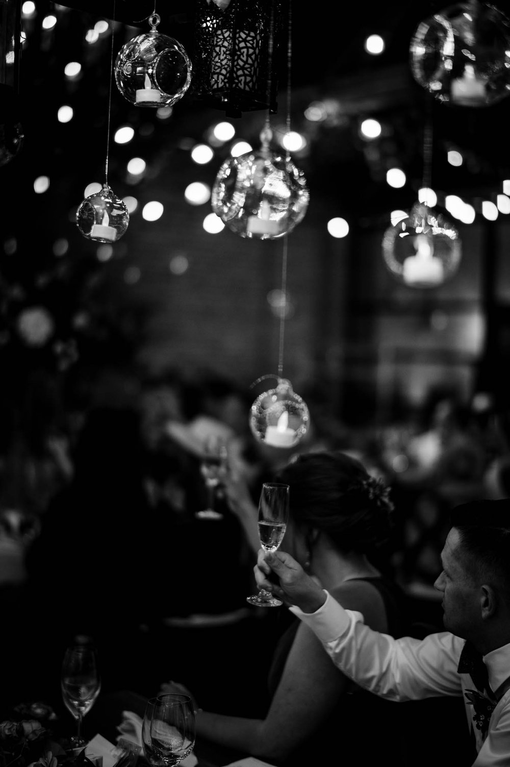 a wedding guest raises their glass after a toast