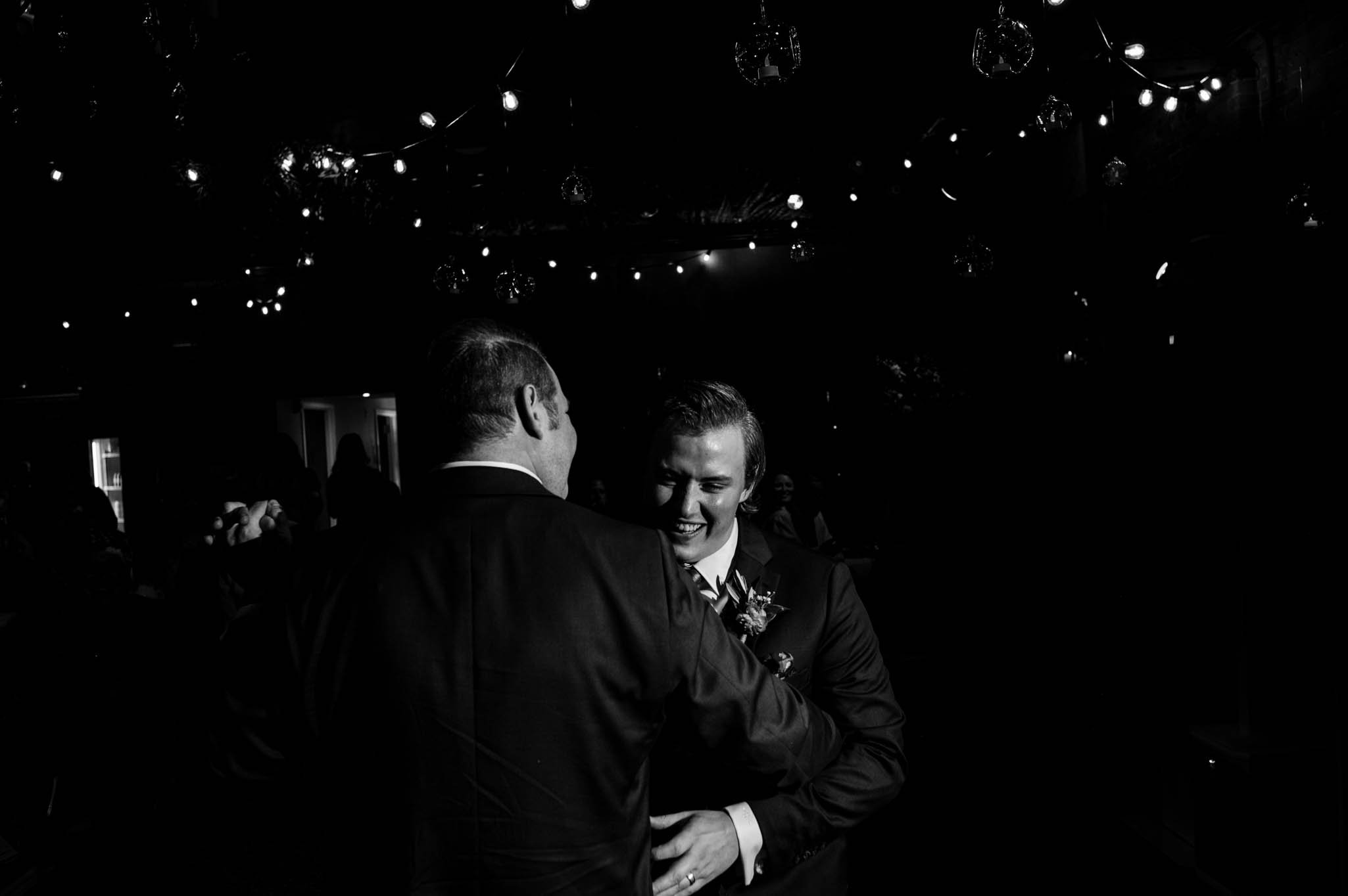 two grooms share their first dance at their wedding