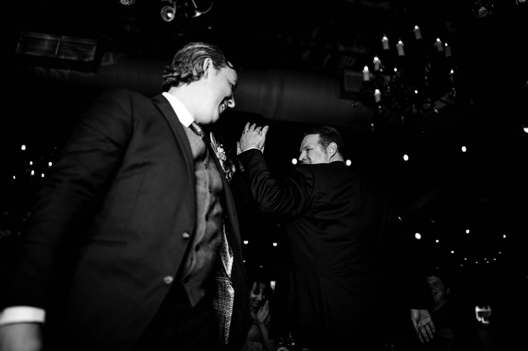 two grooms dancing during their wedding reception